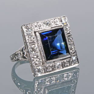 ANTIQUE SAPPHIRE & DIAMOND RING: Designed as a synthetic blue sapphire bezel mounted in a border of colorless melee diamonds in an engraved platinum ring 9.7g Provenance: From the estate a of Scarsdale, NY lady