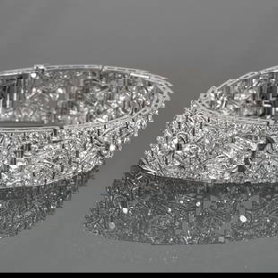 FRENCH ART DECO DIAMOND BRACELET: Style of Cartier; designed as articulating rectangular filigree links mounting set with a line of six old European cut diamonds surrounded with full cut diamonds, with two buckle-form sections with ra
