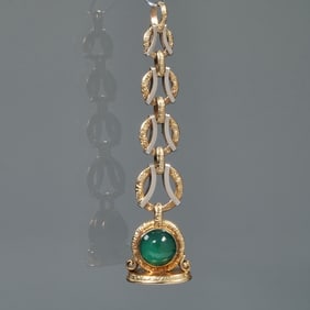 A CHALCEDONY CABOCHON & ENGRAVED 14K GOLD WATCH FOB