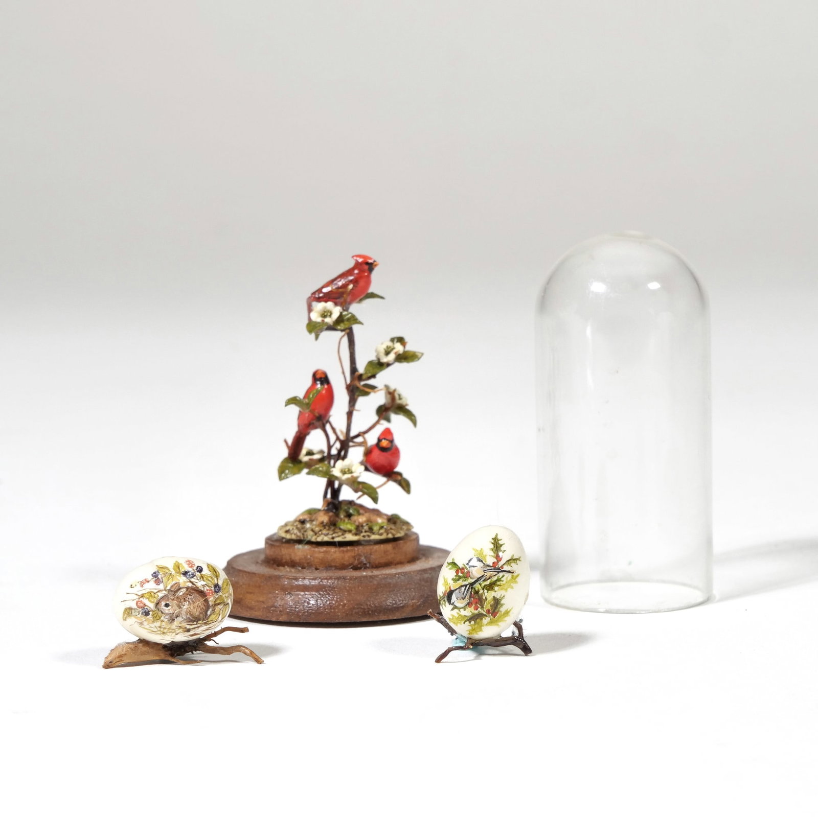 (3pc) MARY MCGRATH MINIATURE DISPLAY OBJECTS: Hand-painted dollhouse miniature decorative objects, including a bird display and two painted eggs, each piece signed and dated - h. 2 x dia. 1.5 in. (display) Provenance: The lifetime collection of a