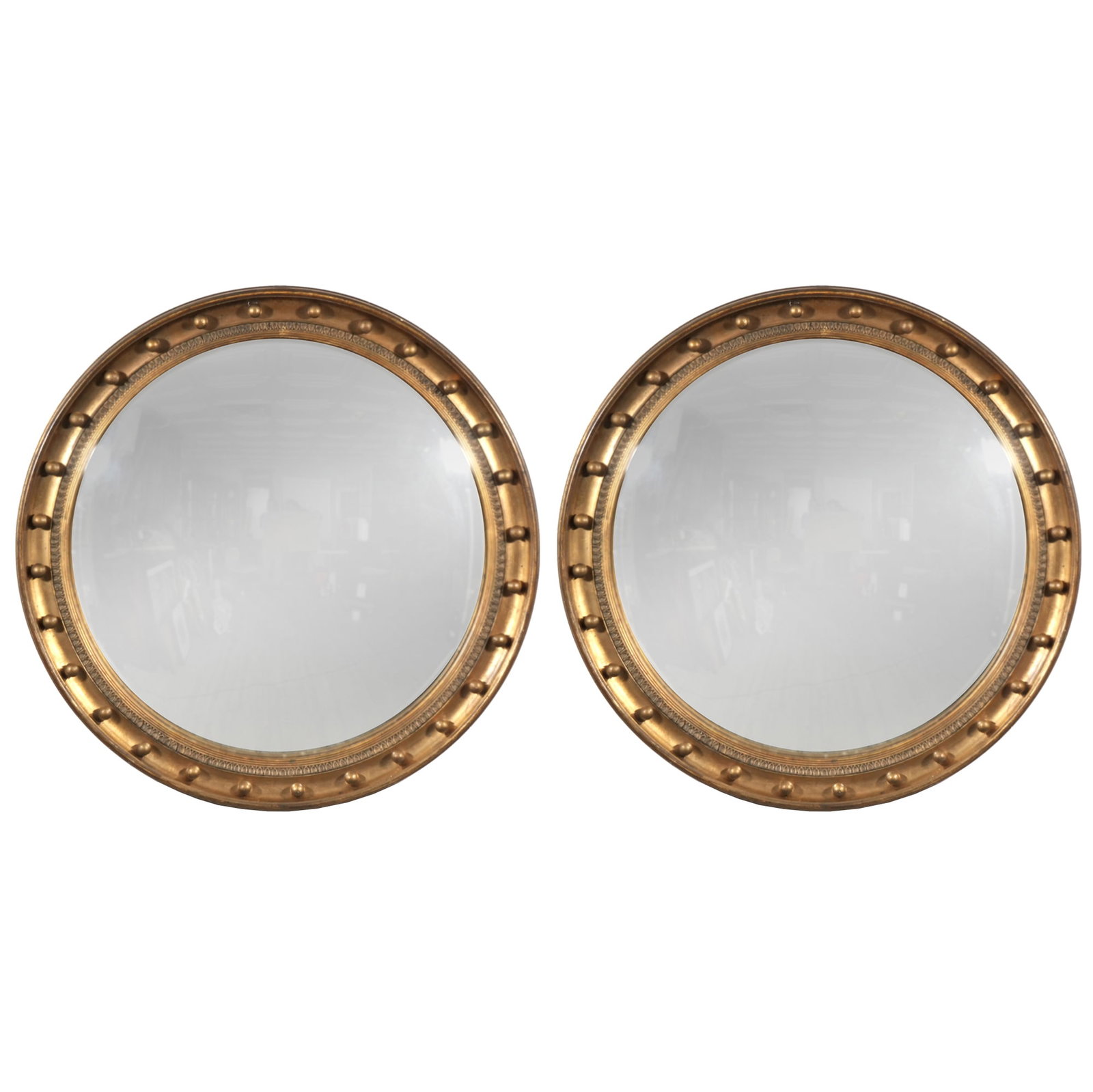 PAIR GILT CONVEX MIRRORS, HILFIGER COLLECTION: 20th century, each mirror with gilt carved wood frame and formed beaded border - dia. 29.5 in. Provenance: Items from the private collection of Susie Hilfiger, Greenwich, CT