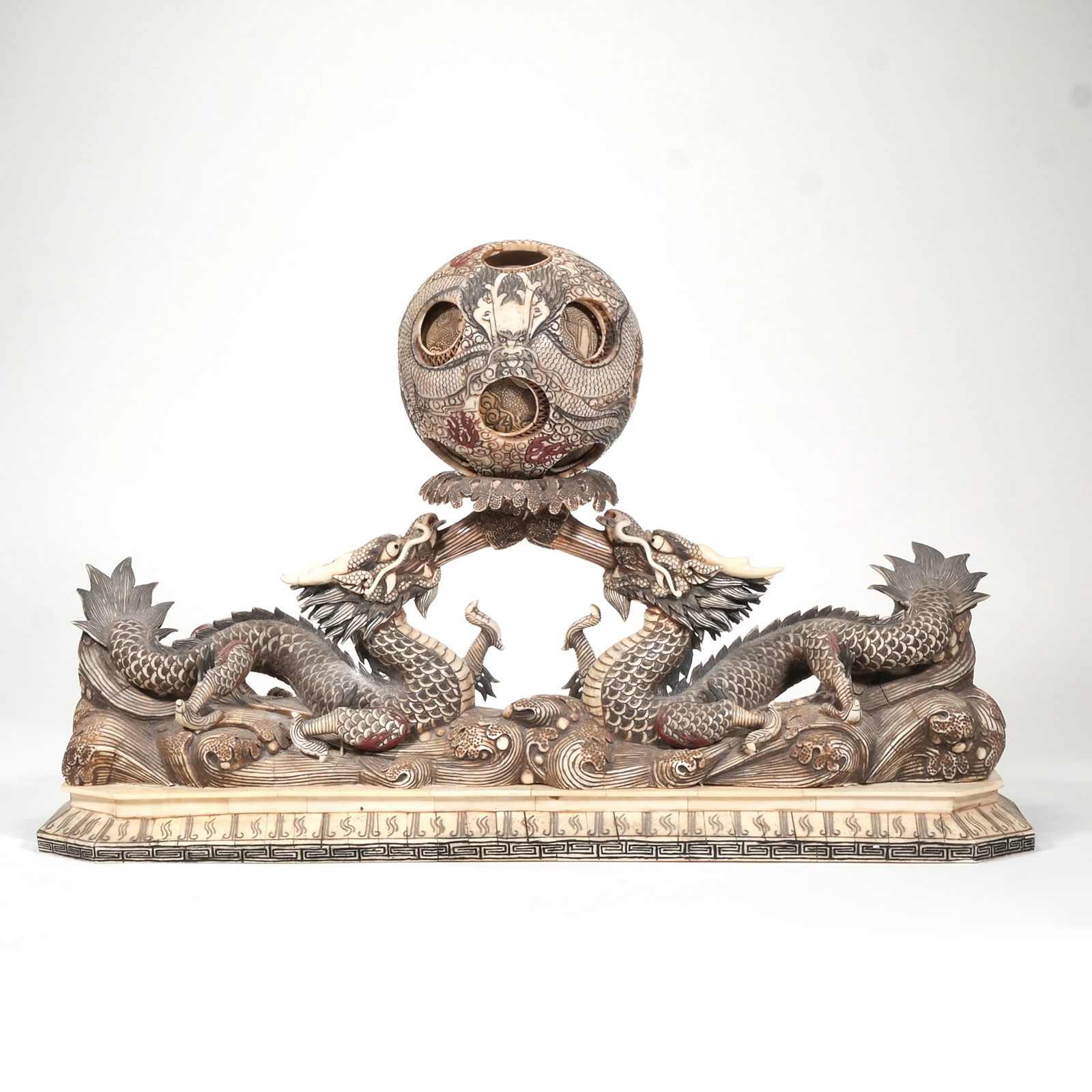 20TH CENTURY JAPANESE CARVED BONE FIGURAL GROUP: Two dragons with layered sphereh. 16 x w. 7 x l. 25.75 in. Provenance: Items from a collector's estate, Purchase, NY