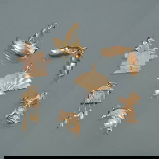 (8pc) GROUP OF 14K GOLD CHARMS: Including a sailboat (marked 14k); an articulating cuckoo clock (no apparent mark); a poodle holding a shoe (marked 14k), a hand fan with pearl (marked 14k): a dolphin with seed pearl (marked 14k); a