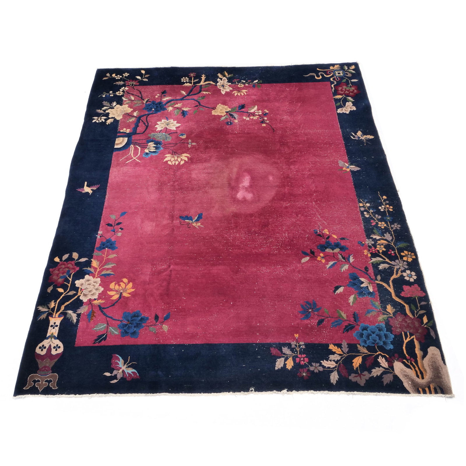 ANTIQUE ART DECO CHINESE FLORAL RUG: Blue border on a red ground, the corners decorated with branches, blooming flowers, and a sculpted vase Provenance: Items from the waterfront home of a private collector, Shippan Point, Stamford, CT 1