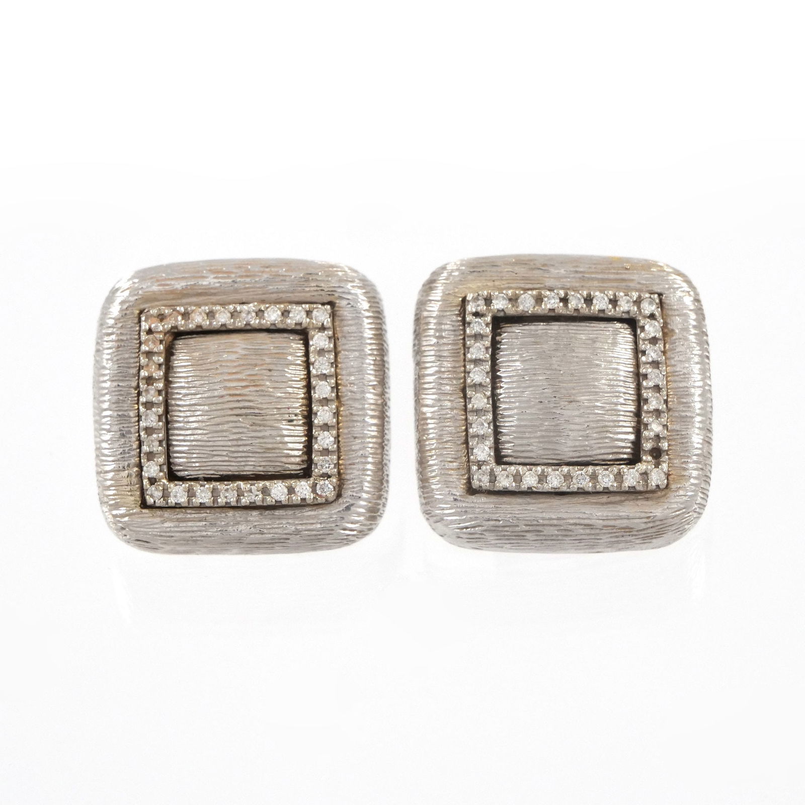ITALIAN 18K WHITE GOLD EARCLIP EARRINGS: Textured white gold with diamonds, having omega backs, marked '18k Italy'; 23.2g l. .75 in.