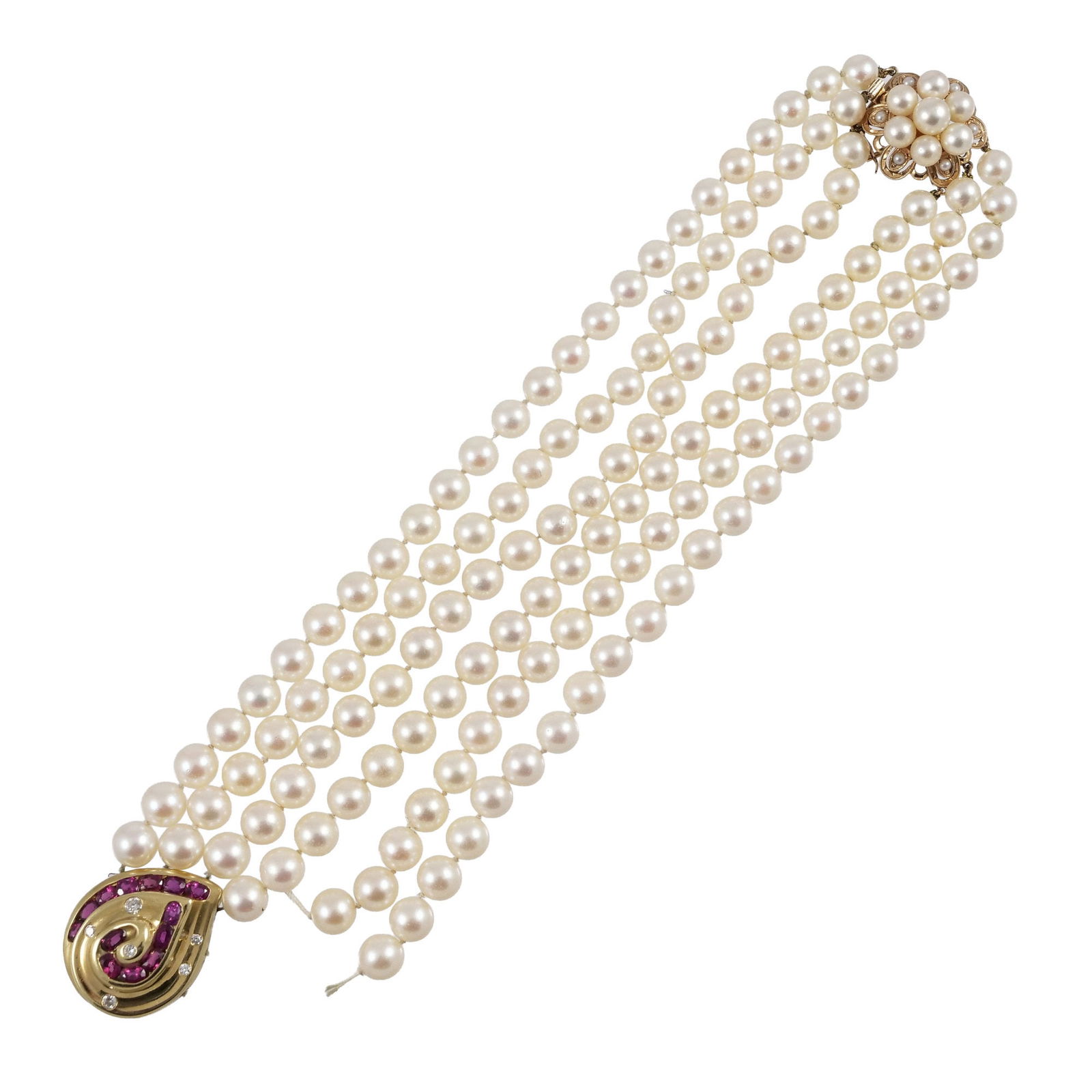 TESS & OTHER TRIPLE STRAND PEARL NECKLACE: A triple strand of hand-knotted pearls terminating in an 18k yellow gold pendant with channel-set oval rubies (or other red stones) and round diamond accents, marked 'TESS 18k', and having a pearl and