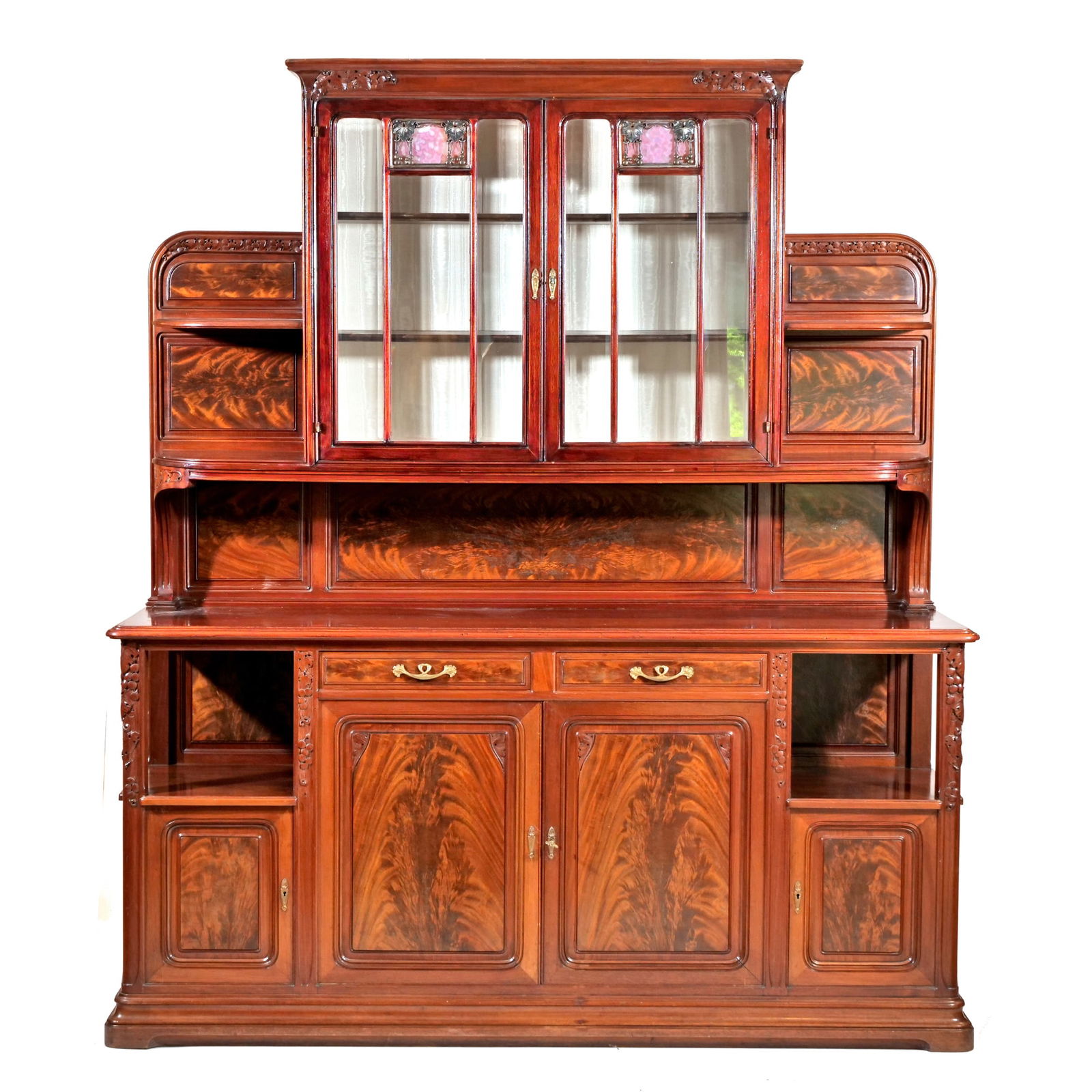 AN IMPORTANT LOUIS MAJORELLE "BUFFET DEUX CORPS" SIDEBOARD CABINET: Sideboard display cabinet or "buffet duex corps" profusely carved with grapevine motif, stained glass panels with metal grapevine overlay, supports and mouldings carved with grapes and grape leaves, b