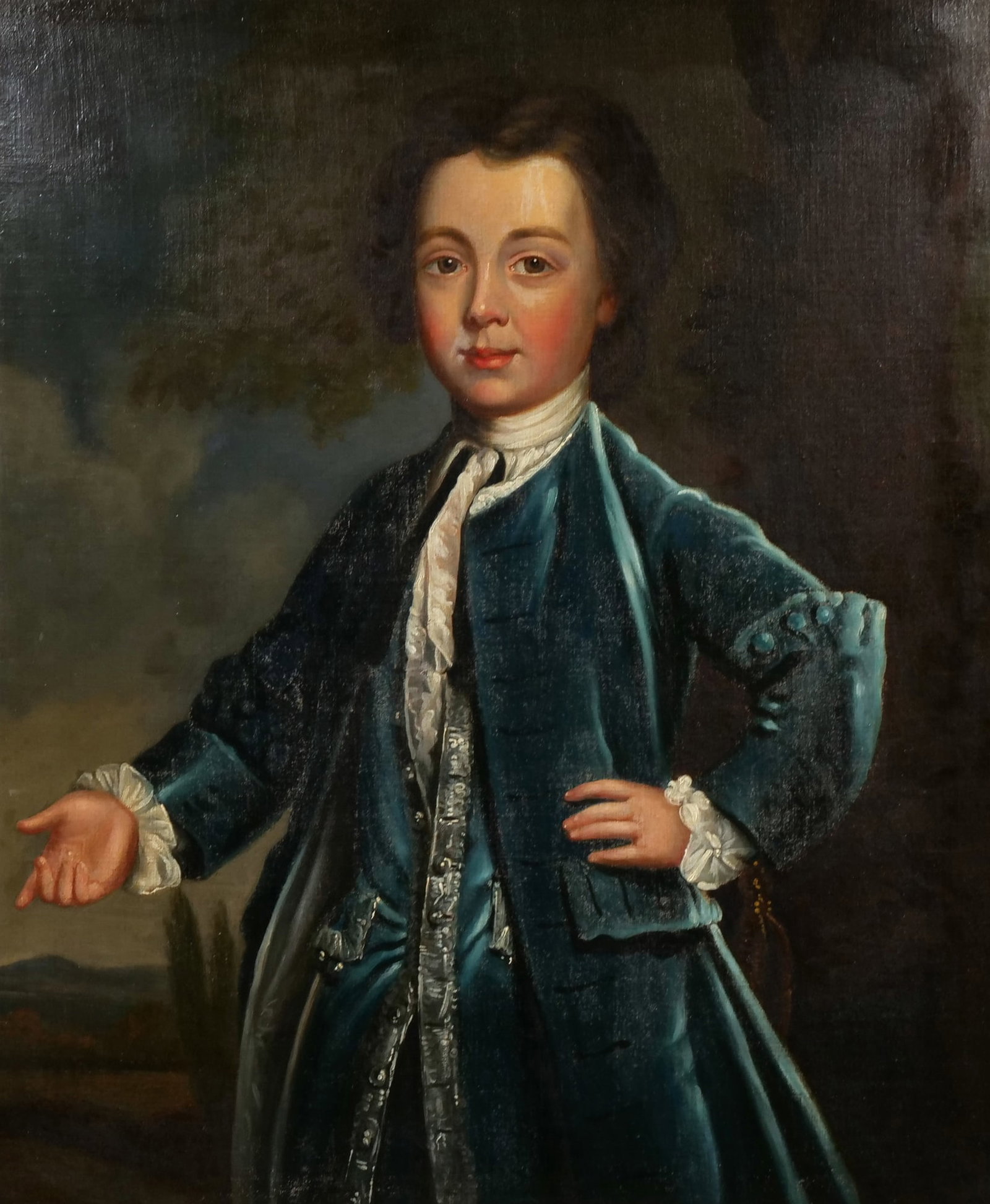 ENGLISH SCHOOL (18TH CENTURY) OIL PAINTING: Portrait of a Young Boy Oil on canvas h. 30.5 x w. 25 in., stretcher The subject is depicted half-length wearing a blue velvet coat with a lace cravat and silver-trimmed waistcoat. The painting is hou