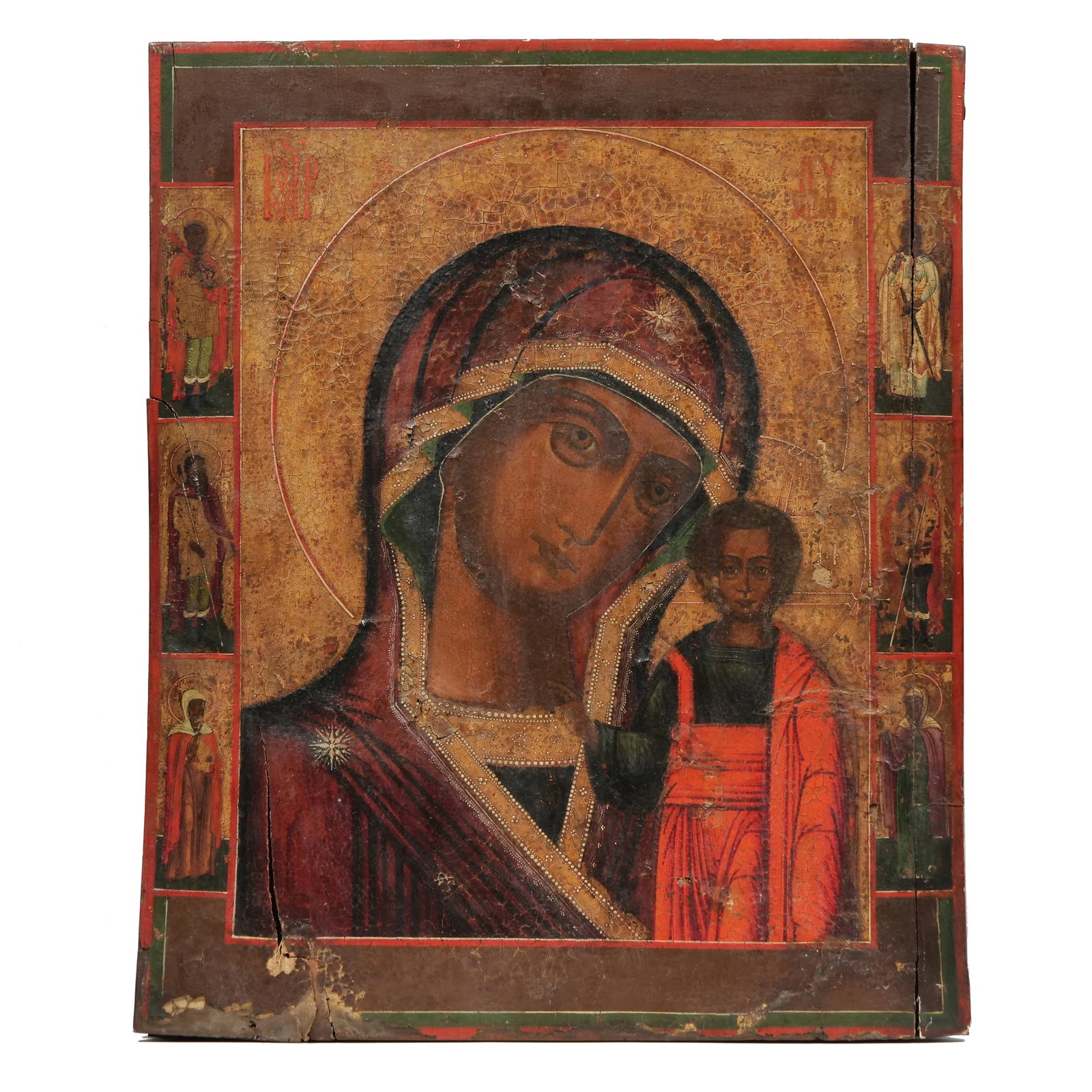 RUSSIAN SCHOOL (19TH CENTURY) ICON: Kazan Mother of God with Selected Saints Tempera and Gilt on Wood Panel h. 18.75 x w. 16.25 in. Central composition of the Virgin Mary and Christ Child surrounded by a gilt background with red Cyrilli