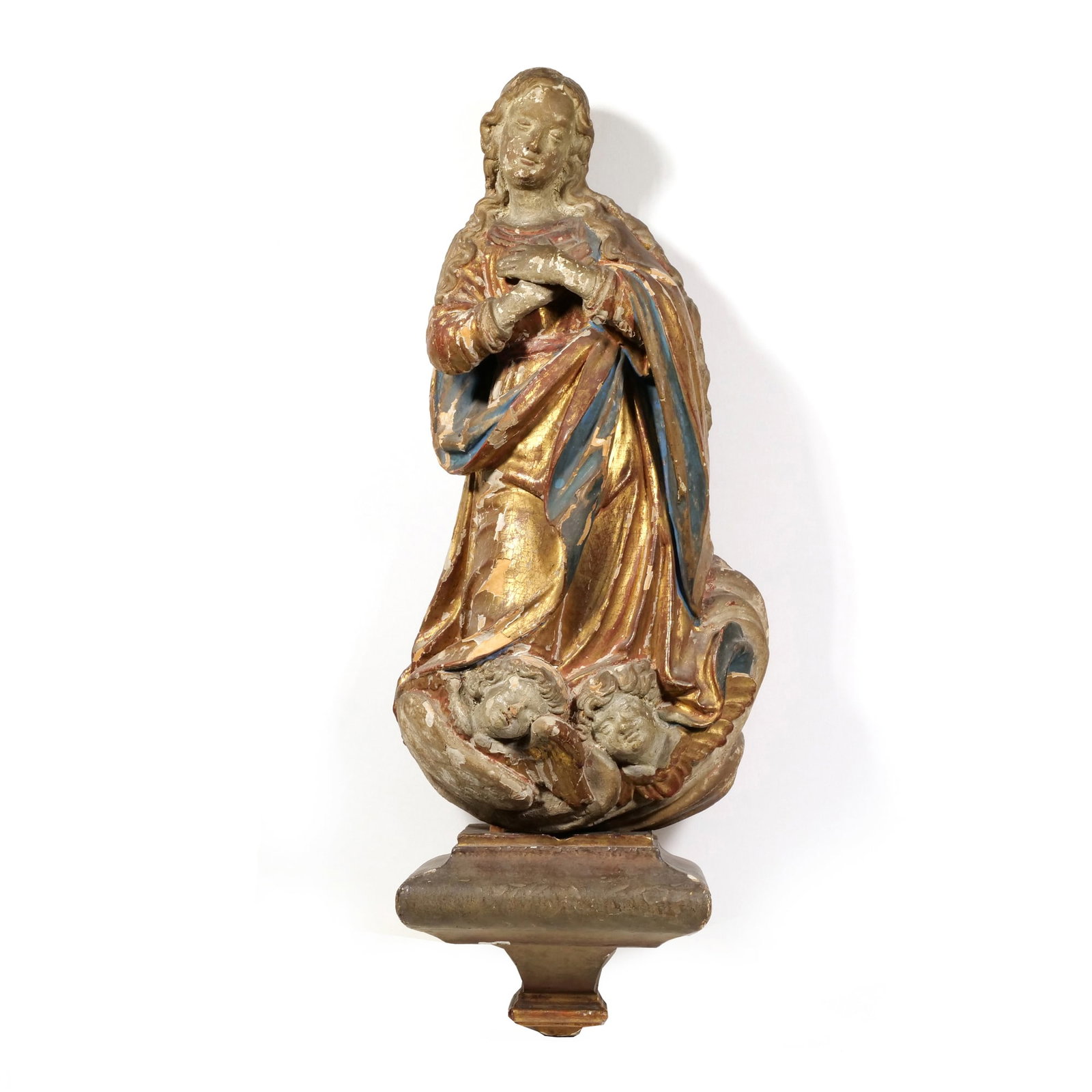 SPANISH COLONIAL SCHOOL (18TH CENTURY) POLYCHROME ESTOFADO RELIGIOUS CARVING: Immaculate Conception Polychrome and gilt wood The figure is depicted with hands joined in prayer, featuring a color palette of gold, blue, and red with a visible craquelure surface. - h. 20 x w. 11 x
