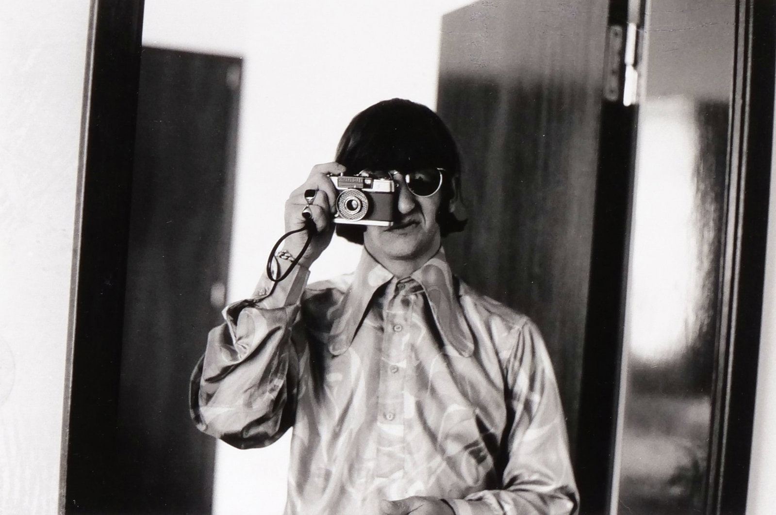 RINGO STARR FRAMED PHOTOGRAPH: A black and white photo of The Beatles drummer, Ringo Starr MBE (born Richard Starkey, July 7, 1940), photographed at the Four Seasons Hotel in Munich on June 23, 1966, with a 'Statement of Authentici