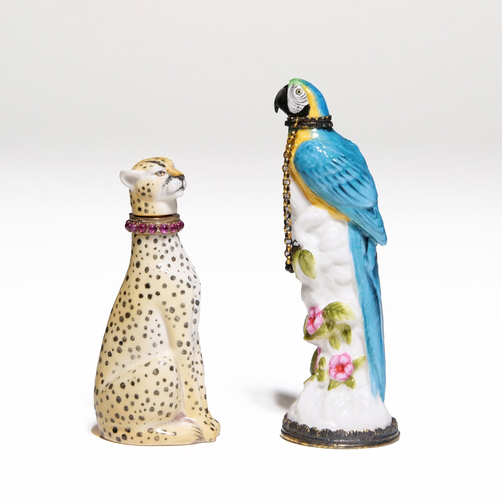 (2pc) HALYCON DAYS FIGURAL SCENT BOTTLES: Including a hand-painted Halcyon Days porcelain cheetah scent bottle with a 9k gold & ruby (or other red stone) collar, with '375' gold and other hallmarks at the collar, and with 'HD' maker's mark, a