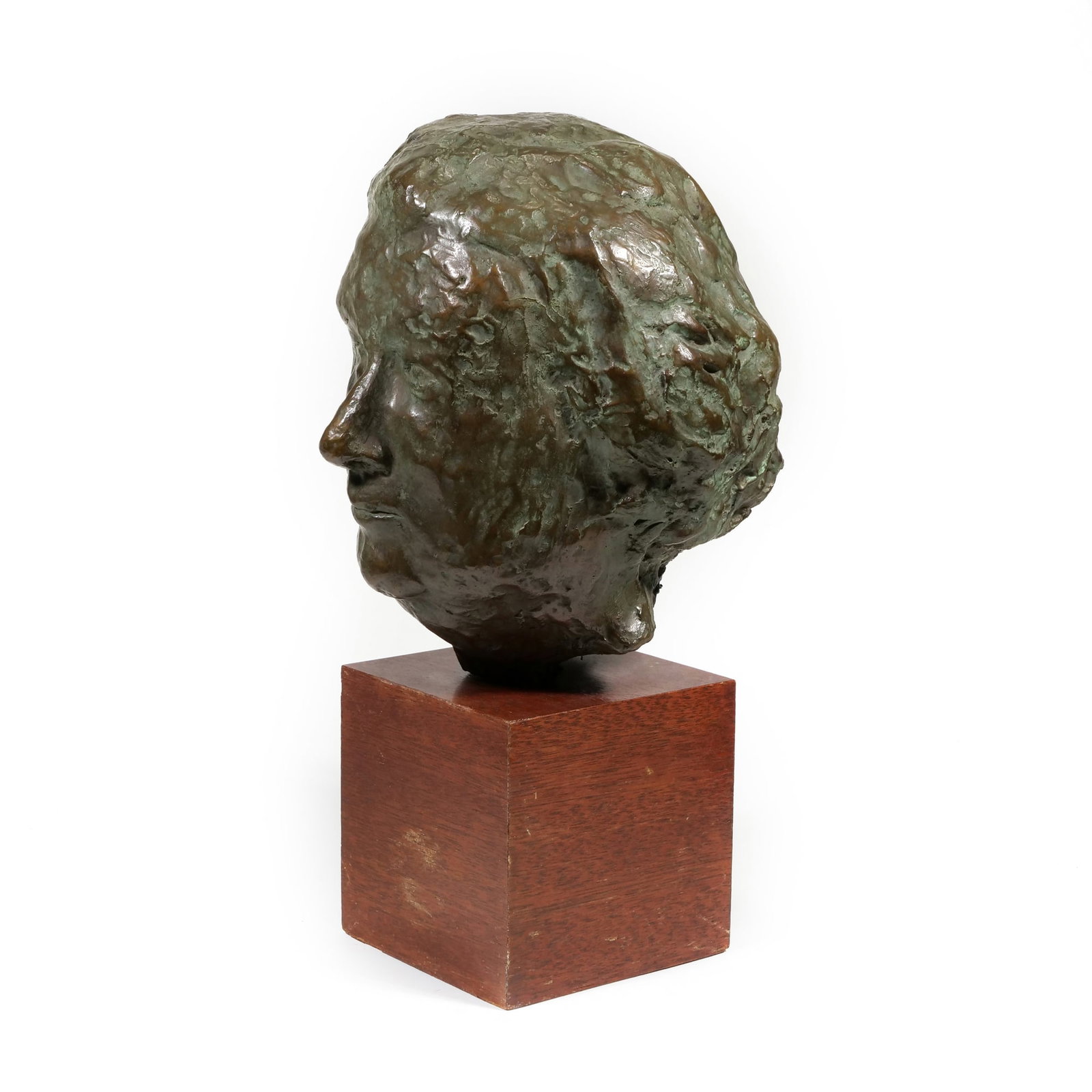 CONTEMPORARY (20TH CENTURY) BRONZE SCULPTURE: untitled (Portrait Bust) Bronze h. 18 in., overall; bust w. 11 in.; plinth w. 6 x l. 6 in. Unsigned; the cast features a highly modeled, expressive surface with a variegated green and brown patina and