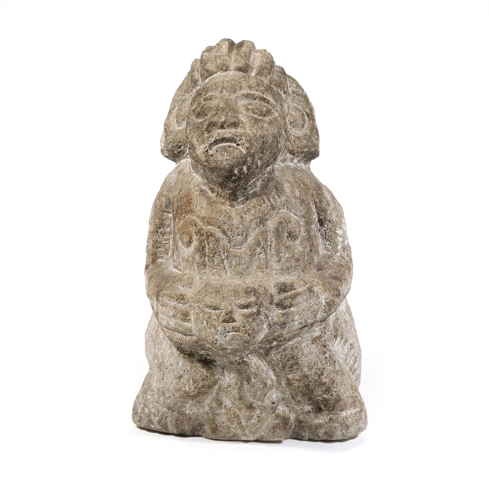 MESOAMERICAN VOLCANIC STONE SCULPTURE: untitled Volcanic Stone Unsigned, seated figure with a tiered headdress holding a secondary mask or vessel carved in a stylized manner.The sculpture exhibits stylistic characteristics associated with