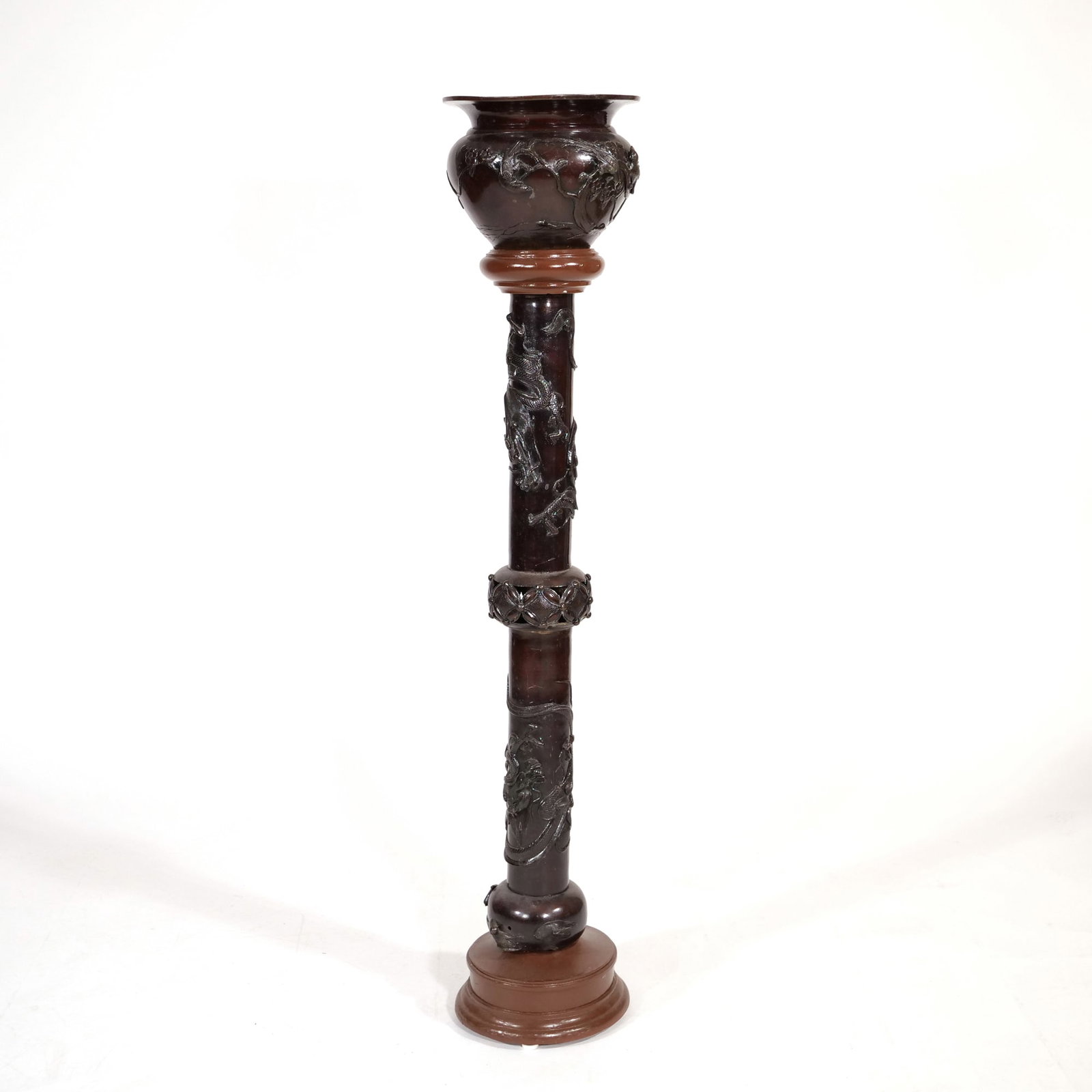 JAPANESE MEIJI PERIOD PATINATED BRONZE LAMP BASE: Bronze floor lamp base featuring high-relief decoration of winding dragons and avian figures, the upper portion having a flared, vase-form top with bird and floral motifs. The central column is embell