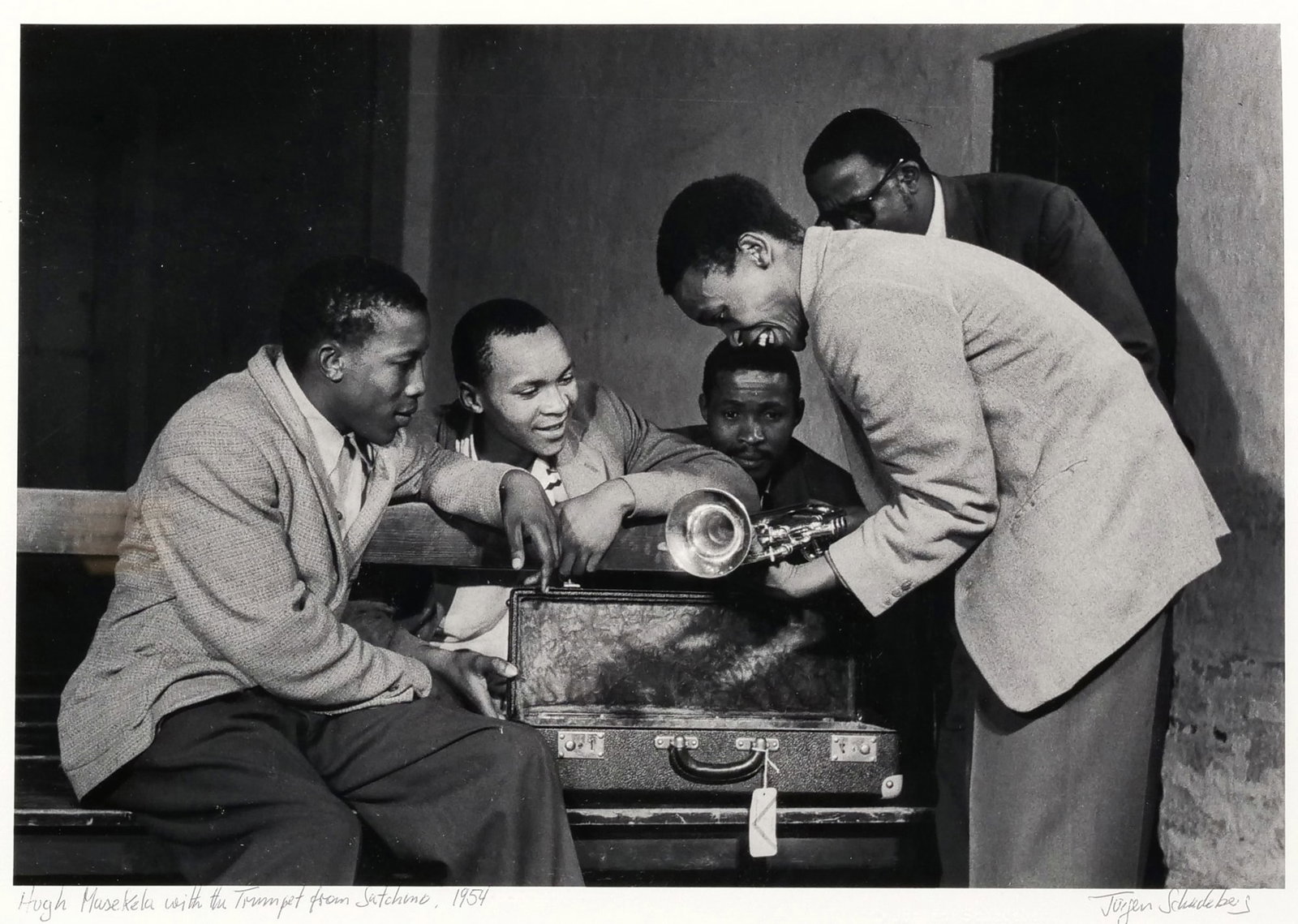 JURGEN SCHADEBERG (GERMAN/SOUTH AFRICAN, 1931-2020) JAZZ PHOTOGRAPH: Hugh Masekela with the Trumpet from Satchmo, 1954Further identified by label on verso: [Father Trevor Huddleston, activist and fan of African music, asked Louis Armstrong to send a trumpet to Hugh Mas