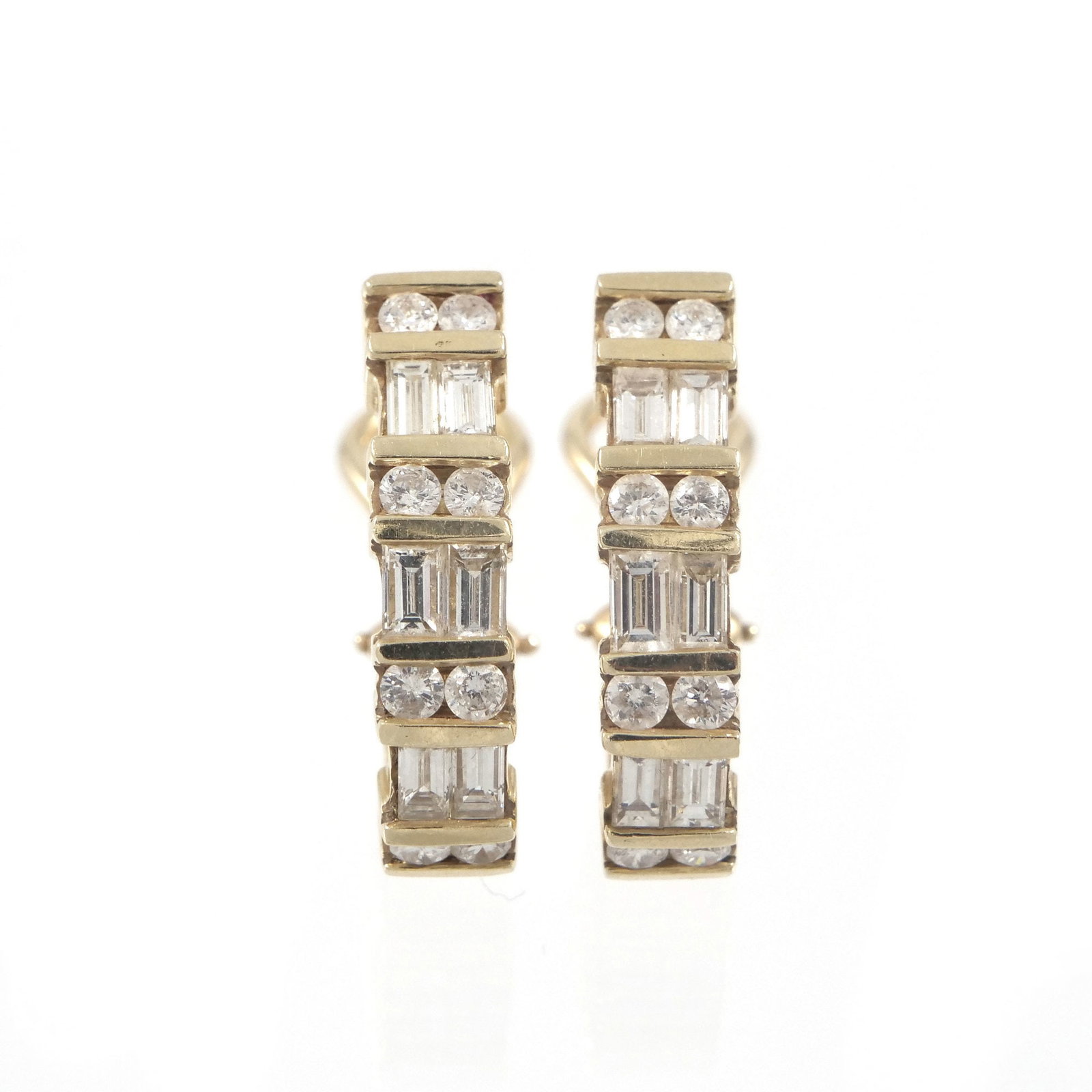 PAIR 14K GOLD & DIAMOND HUGGIE EARRINGS: Set with alternating rows of round or baguette diamonds, with 585 fineness mark and omega backs; 8.5g - l. .75 in. Inventory No. 93-13 Provenance: Items from the estate of a Greenwich, CT lady.