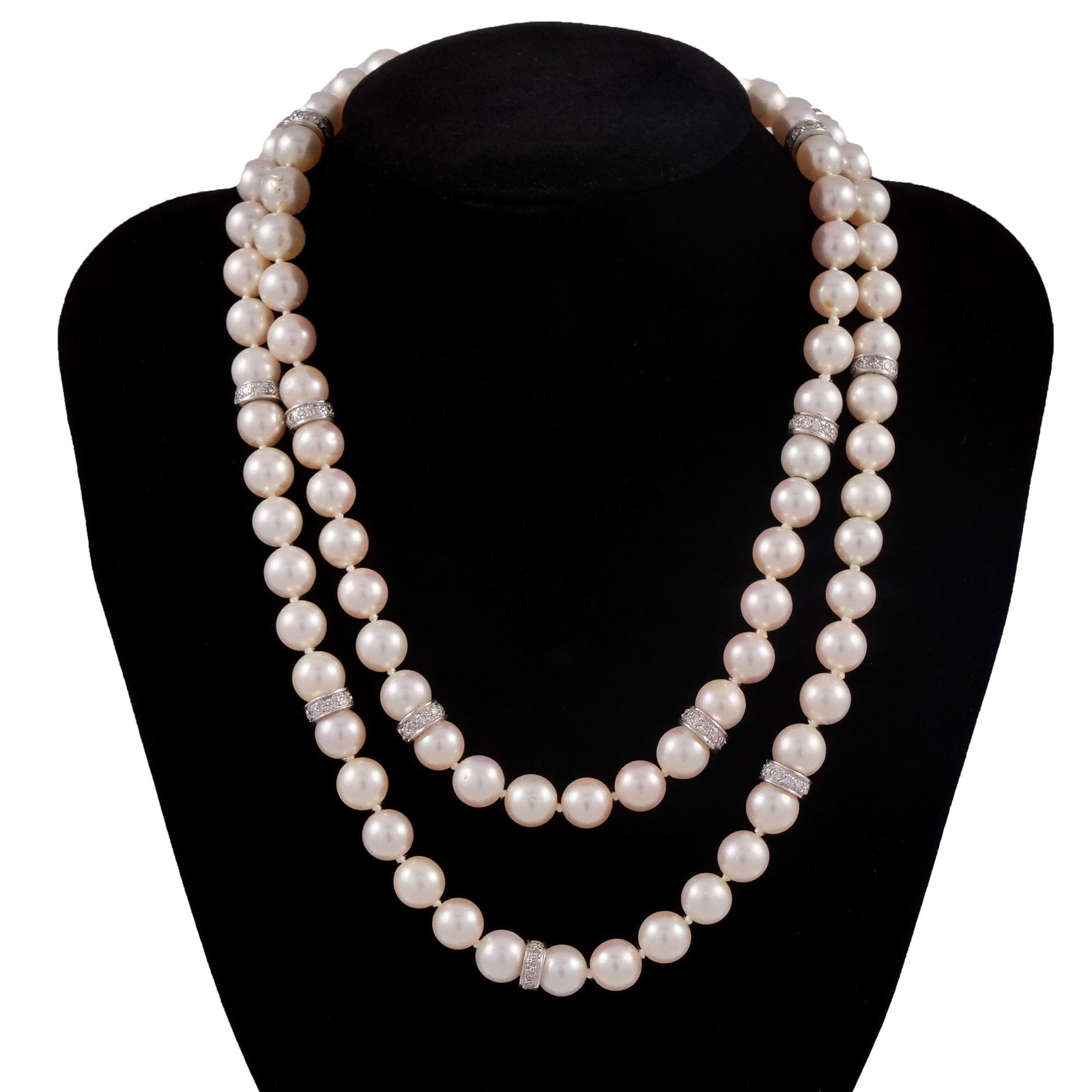 LONG STRAND OF PEARLS WITH PLATINUM & DIAMOND STATIONS: Hand-knotted pearl necklace with 15 diamond and platinum stations, no clasp, pearls are approx. 9mm; 109.5g - l. 32 in. Inventory No. 93-33 Provenance: Items from the estate of a Greenwich, CT lady.