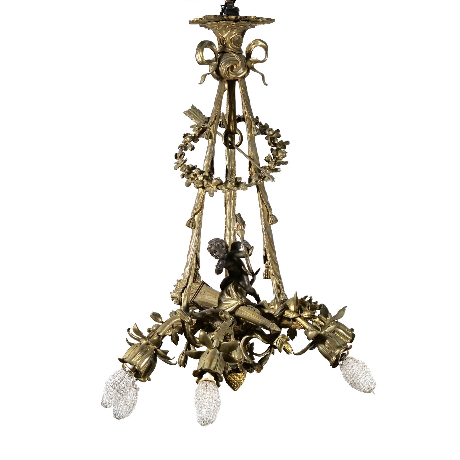 FRENCH LOUIS XVI STYLE GILT AND PATINATED BRONZE SIX-LIGHT CHANDELIER: Neoclassical six-light chandelier featuring a central dark patinated bronze putto holding a torch. The gilt bronze frame is decorated with floral wreaths, crossed arrows, putto, and ribbon-tied tassel