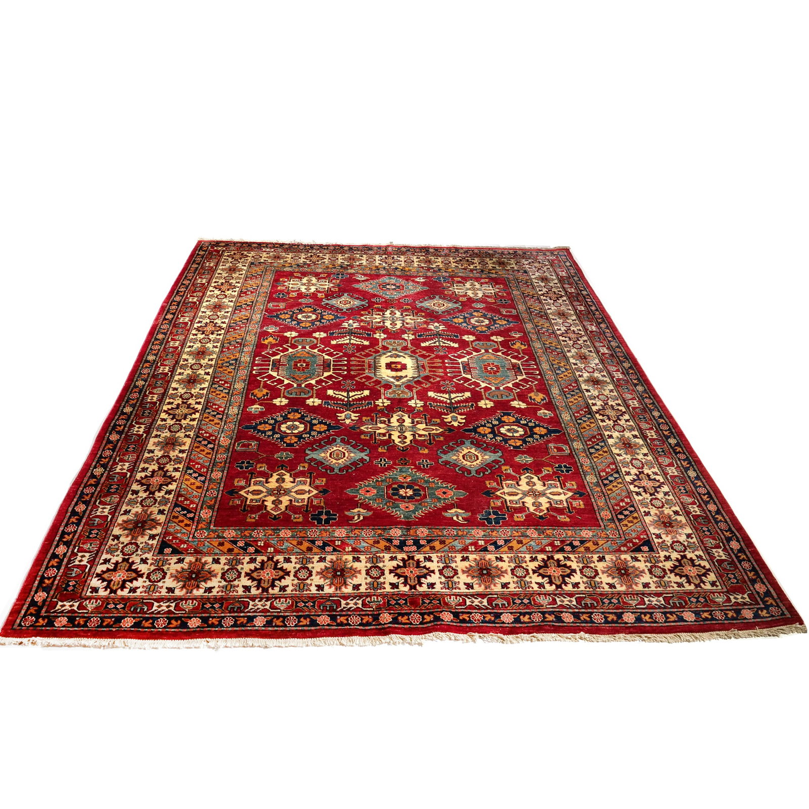 AN AFGHAN KAZAK WOOL RUG: Hand-knotted wool rug featuring a red field decorated with geometric and star-shaped medallions. The color palette includes primary tones of red, cream, and blue with yellow accents throughout. The