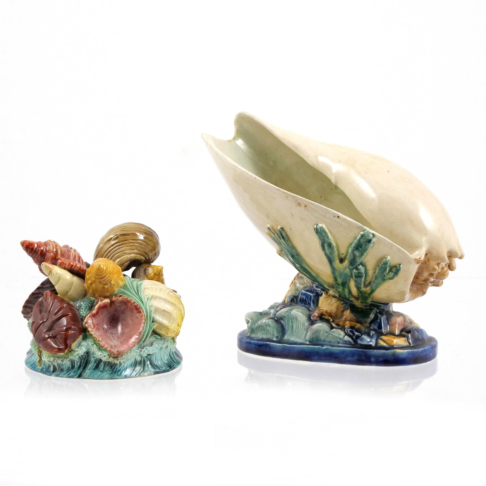 (2pc) GLAZED CERAMIC SHELLS: The taller is a ceramic vase designed in the shape of a shell ('muschel') on a pedestal base adorned with relief seaweed or underwater details, and with impressed 'T.S' mark to base, likely for
