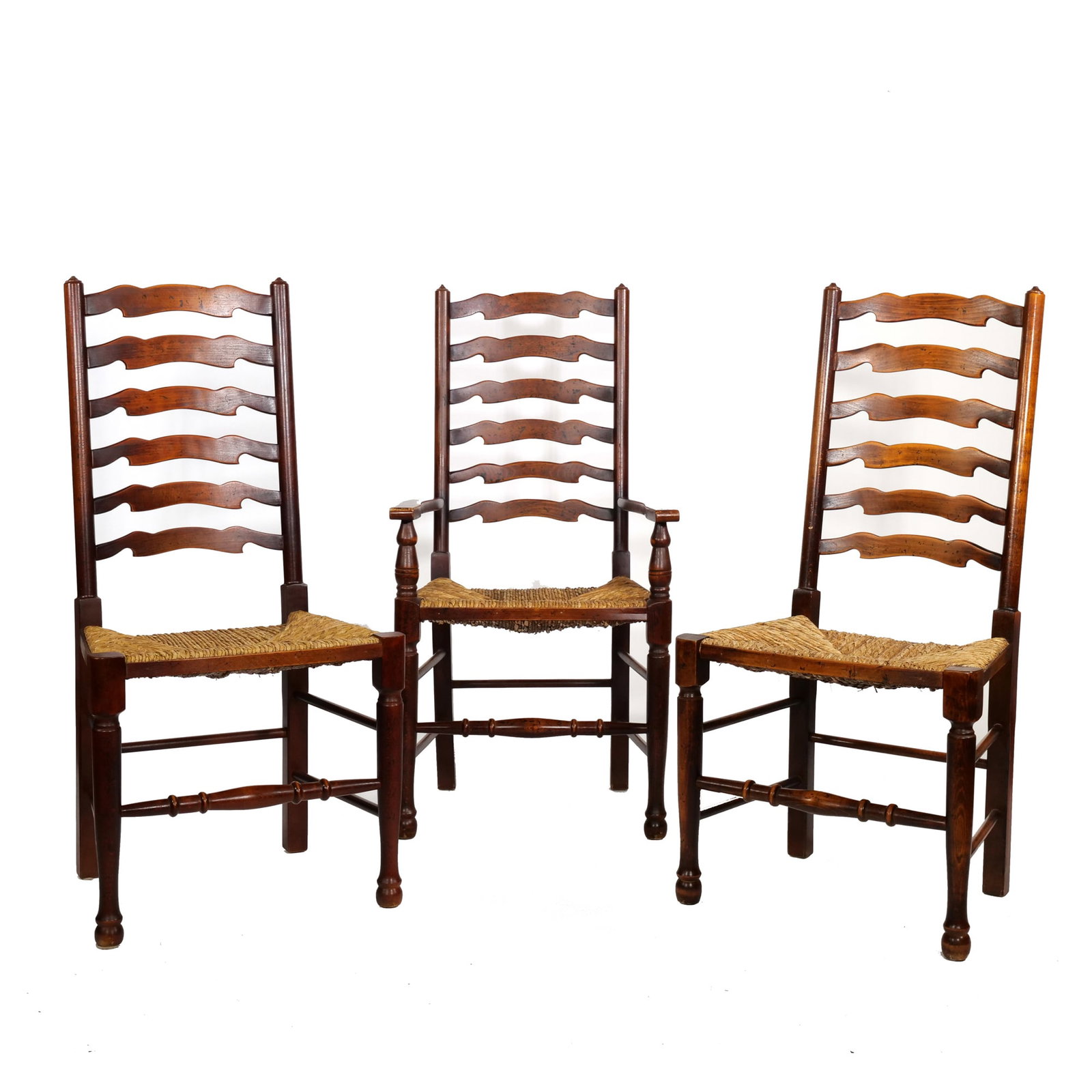 (3pc) LADDER BACK DINING ROOM CHAIRS WITH RUSH SEATS: Including one armchair and two side chairs, each featuring a six-slat scalloped ladder back and turned finials; seat height 18.5 in. - h. 44 x w. 21.5 x d. 16.5 in. Inventory No. 1AA-49 Provenance: Fr