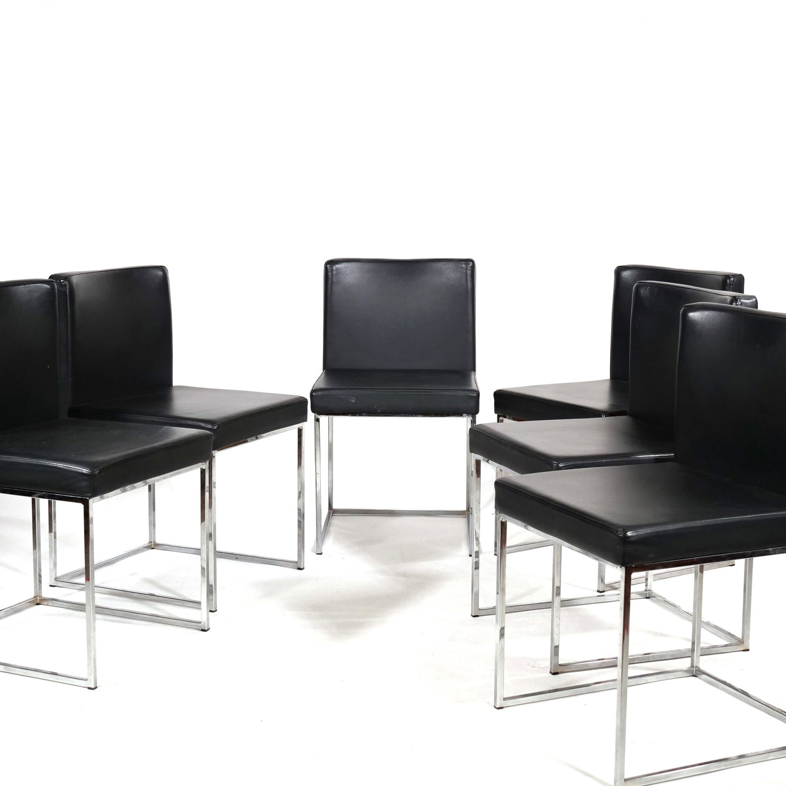 CALLIGARIS 'EVEN PLUS' CHROME AND BLACK UPHOLSTERED DINING CHAIRS: Set of six dining chairs featuring chrome-plated square tubular metal frames with a sled-style base. The chairs are upholstered in black material on the seat and rectangular backrest. Undersides featu