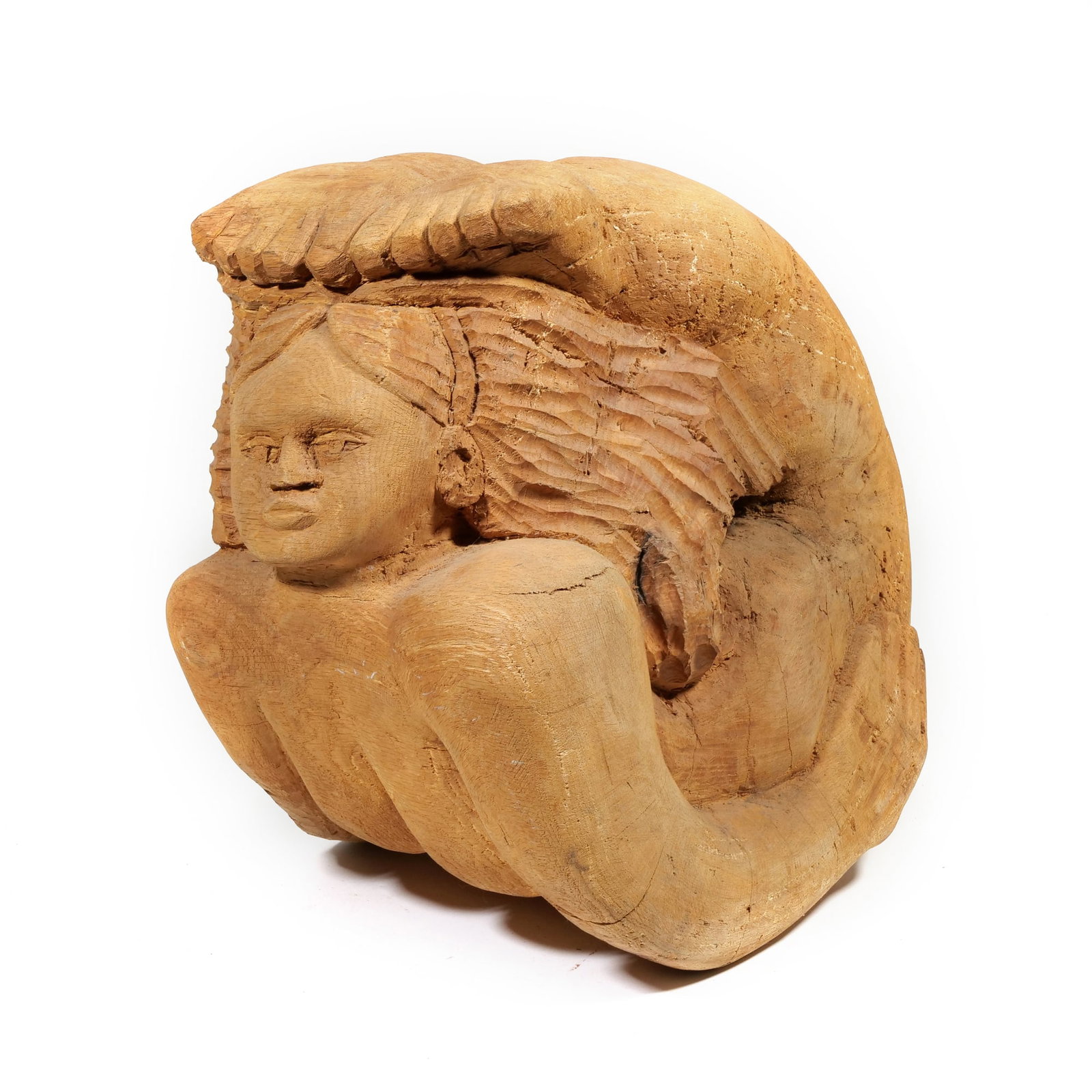 LATE 19TH/ EARLY 20TH C. FOLK ART CARVED WOOD SCULPTURE: coiled siren Carved wood h. 13 x w. 9.5 x d. 14.5 in. Carved from a solid log section, the sculpture depicts a female figure, with arched back head extended forward, swirling back on herself. The hair