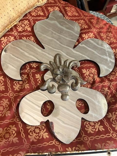 Contemporary Fleur-Di-Lis: Contemporary Fleur-Di-Lis, famous symbol of New Orleans, small decorator mirror, front has same design and a flower of metal in center medallion, has black wooden back. 20" x 16"