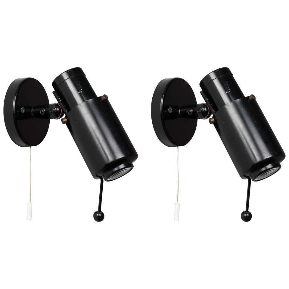 Pair of 1950s Jacques Biny 'Zodiac' Wall Lights for Lita: Quantity: 2 lamps Pair of 1950s Jacques Biny 'Zodiac' Wall Lights for Lita. Executed in black painted metal, glass and brass for Lita. Retain original manufacture's label and rare on or off pulls with