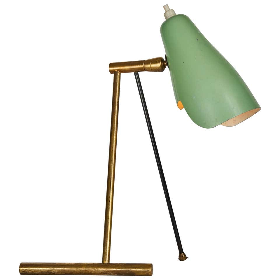 1950s Stilnovo Wall or Table Lamp: Quantity: 1 1950s Stilnovo wall or table lamp. Featuring two sculptural brass and painted metal legs, with the original green lacquered aluminum shade. Unmarked.