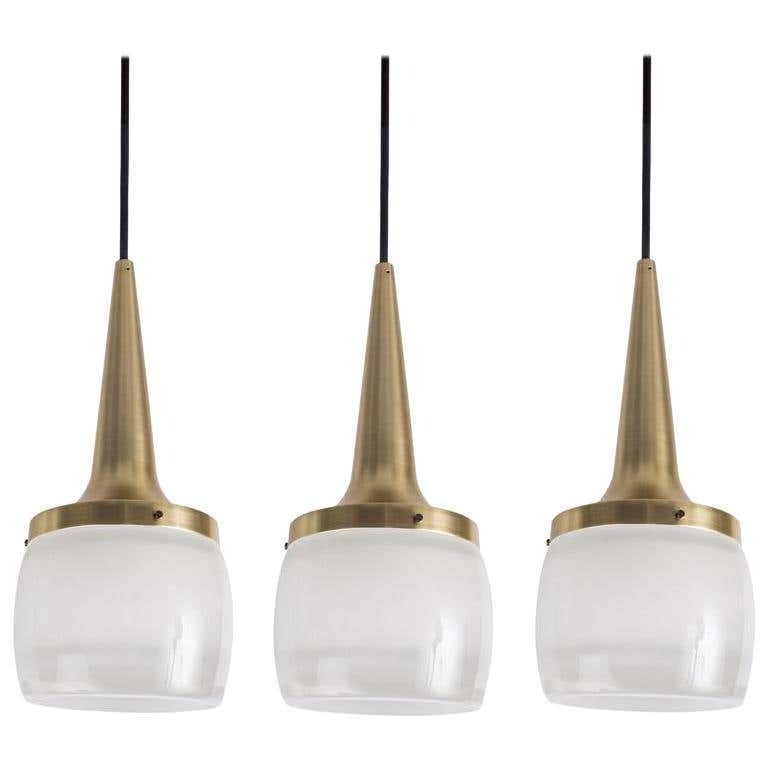 Set of Large 1960s Staff Leuchten Pendants: Quantity: 3 Set of Large 1960s Staff Leuchten pendants. Executed in brassed metal and thick opaline molded glass etched on the inside, with custom solid brass canopy and thick cloth cord.