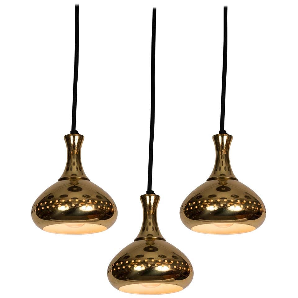 Set of 3 1950s Hans-Agne Jakobsson Perforated Brass Pendants for Markaryd: Quantity: 3 Set of 3 1950s Hans-Agne Jakobsson perforated brass pendants for Markaryd. Original manufacturer's label present on several lamps. Hans-Agne Jakobsson (Designer),AB Markaryd (Maker)