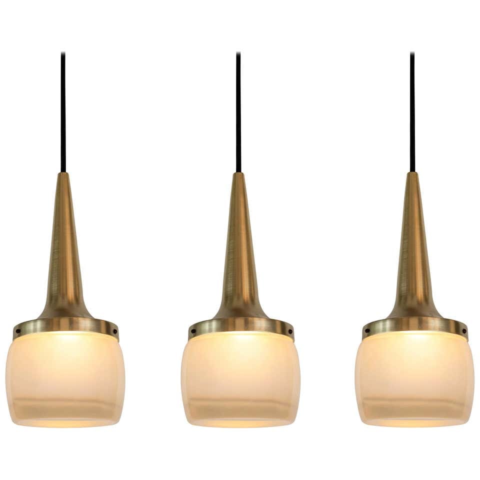 Set of 3 Large 1960s Staff Leuchten Pendants: Quantity: 3 Set of Large 1960s Staff Leuchten pendants. Executed in brassed metal and thick opaline molded glass etched on the inside, with custom solid brass canopy and thick cloth cord.