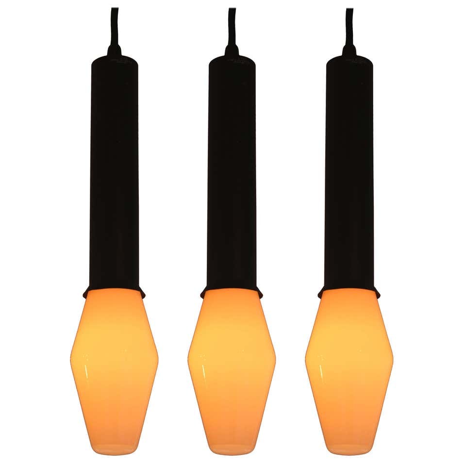 Set of 3 1960s Tapio Wirkkala Pendants for Idman: Quantity: 3 Set of 3 1960s Tapio Wirkkala pendants for Idman, executed in black painted metal and rare original blown-glass architectural bulbs. Retains original manufacturer's label and original boxe