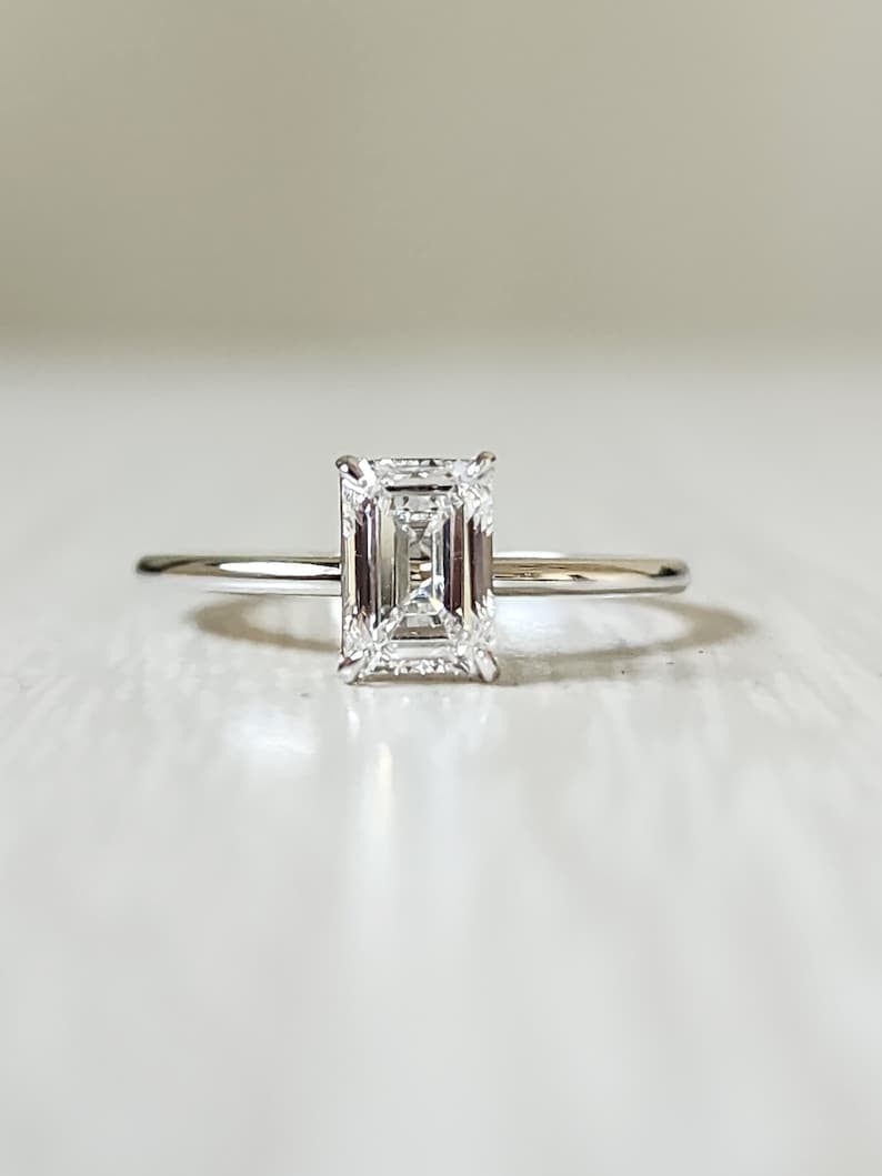Certified 1.50 Carat Emerald Cut Lab Grown Diamond VVS1 E Color 14kt Solid White Gold Engagement: Certified 1.50 Carat Emerald Cut Lab Grown Diamond VVS1 E Color 14kt Solid White Gold Engagement Ring - Ring Size - 6 - Ring Resize Available free of cost - Free Shipping….