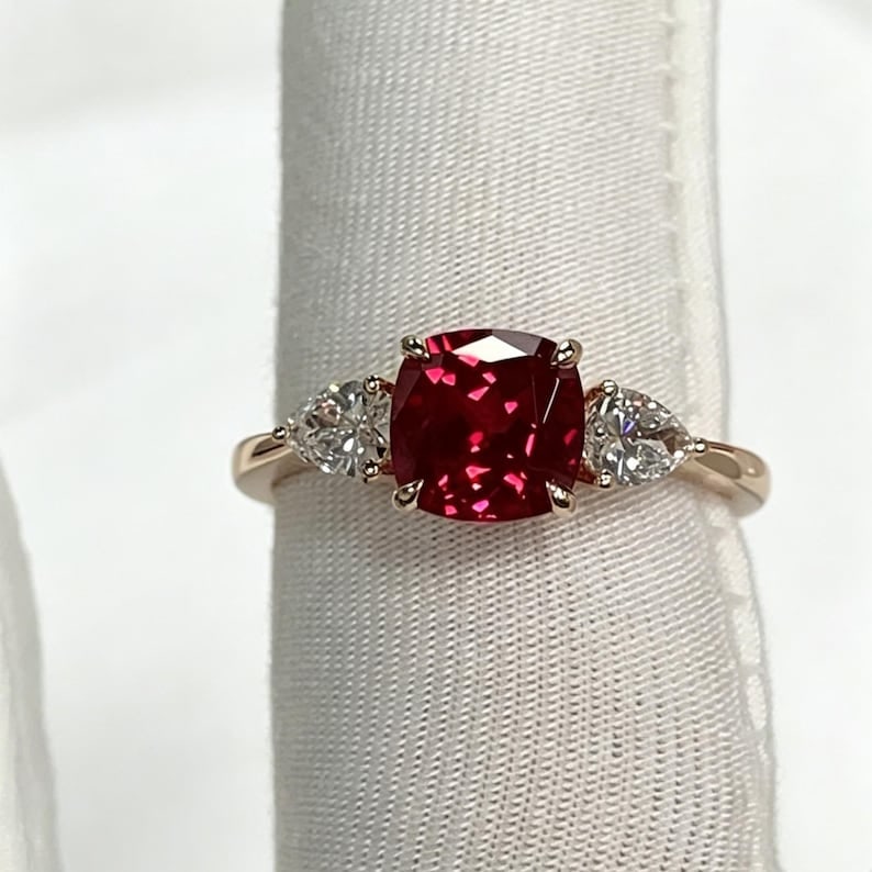 Certified 4.00 Carat Cushion Cut Lab Grown Ruby Engagement Ring in 14K Rose Gold Three Stone Ring |: Certified 4.00 Carat Cushion Cut Lab Grown Ruby Engagement Ring in 14K Rose Gold Three Stone Ring | Luxury Promise Ring |Side Stone Lab Grown Diamonds VVS1 D Color Pear Cut 1.00 ct - Ring Size US 7