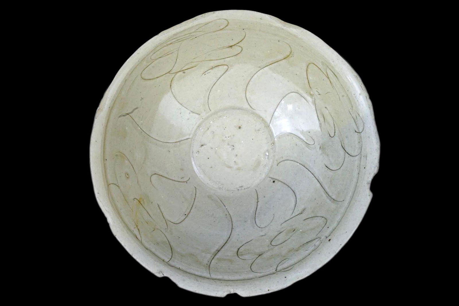 Ancient Glazed Ceramic Bowl, Dai Viet, Annam, Vietnam, around the period of the Chinese Yuan Empire: Ancient Imperial China, Yuan Dynasty, circa 1279 to 1368 CE hand built pottery porcelain bowl with gentle sloped walls and sitting upon ring form feet. The glaze finish is in a pale hue celadon like.