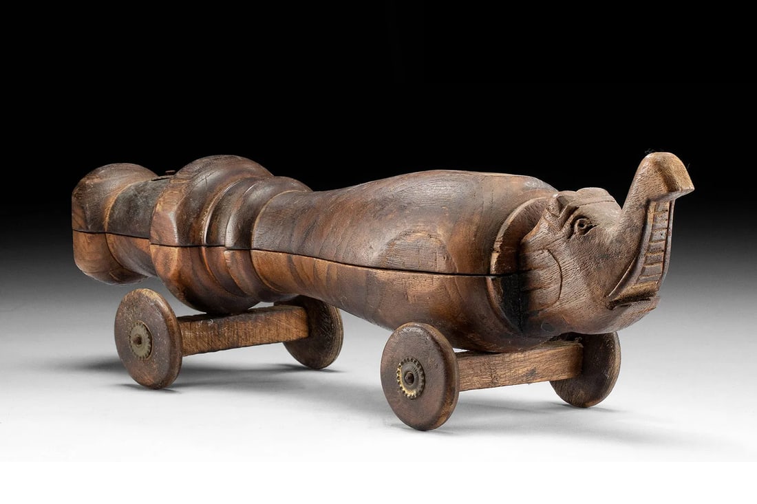 Wooden Elephant Toy, Car With Wheels, South Asia, Colonial India By The Late 19th Century Folk Art: Dimensions, 16 L x 4 W x 4.75 H inches, equivalent to 40.6 cm x 10.2 cm x 12.1 cm. All measurements are approximate. Provenance: private Hawaii, USA collection; ex-Wailuku Gallery, Hawaii, USA. Curren