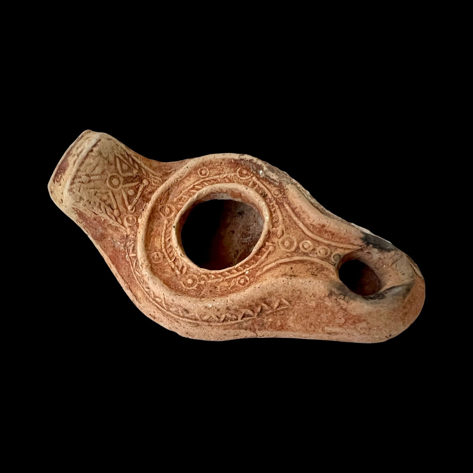 Byzantine Terracotta Oil Lamp with cross, Ca 5th Century AD. Antiquities And Collectibles, History: Ancient Byzantine with cross, dating 5th–6th Century AD, terracotta oil lamp crafted from reddish clay, featuring a rounded central fill hole encircled by incised geometric decoration. The elongated