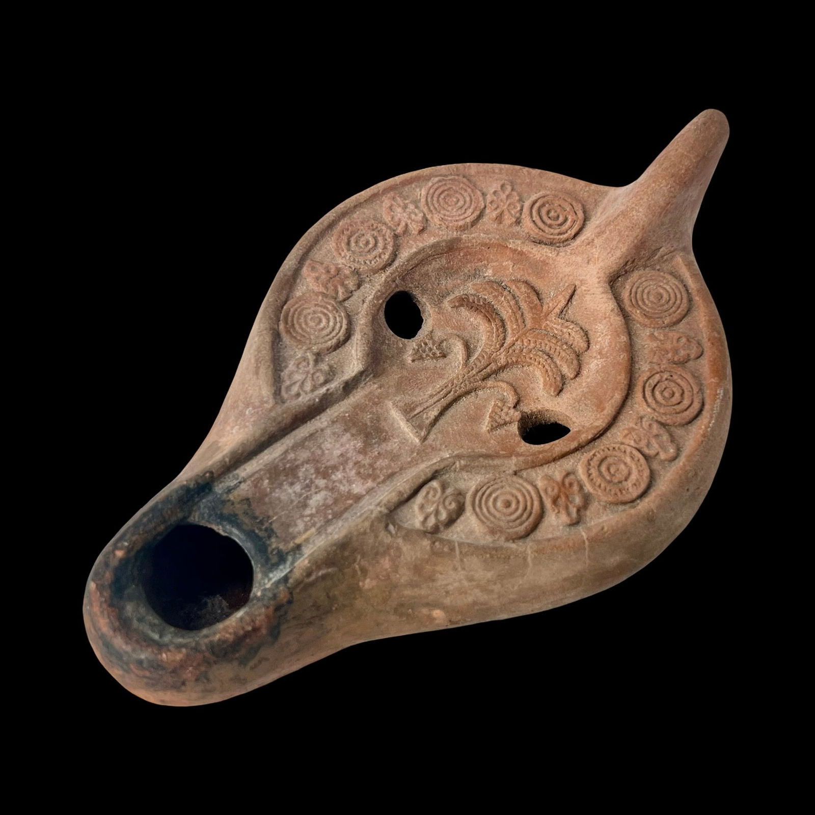 Roman Red Ware Oil Lamp. North Africa.: Roman Red Ware Oil Lamp. North Africa, ca. 3rd-4th century, In relief a palm tree on the discus with a single nozzle and two filling holes. Free from repairs and displayed on a custom plastic holder.