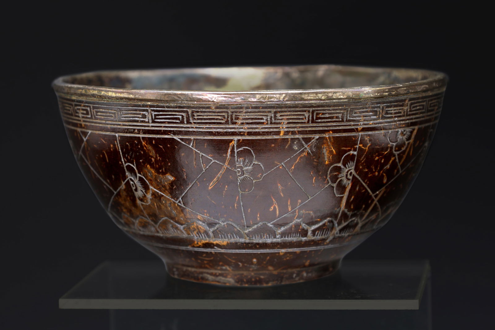 A 19th Century Chinese, Qing Dynasty Libation Bowl, Carved Coconut Shell And Silvered Rim, Asia Arts: Dimensions Diameter 4.5 inches, Height 2.25 inches, All measurements are approximate. Surface wear and aging, scuffs, dings, patina. Sold as pictured. Qing Dynasty Libation Bowl, 19th Century Chinese