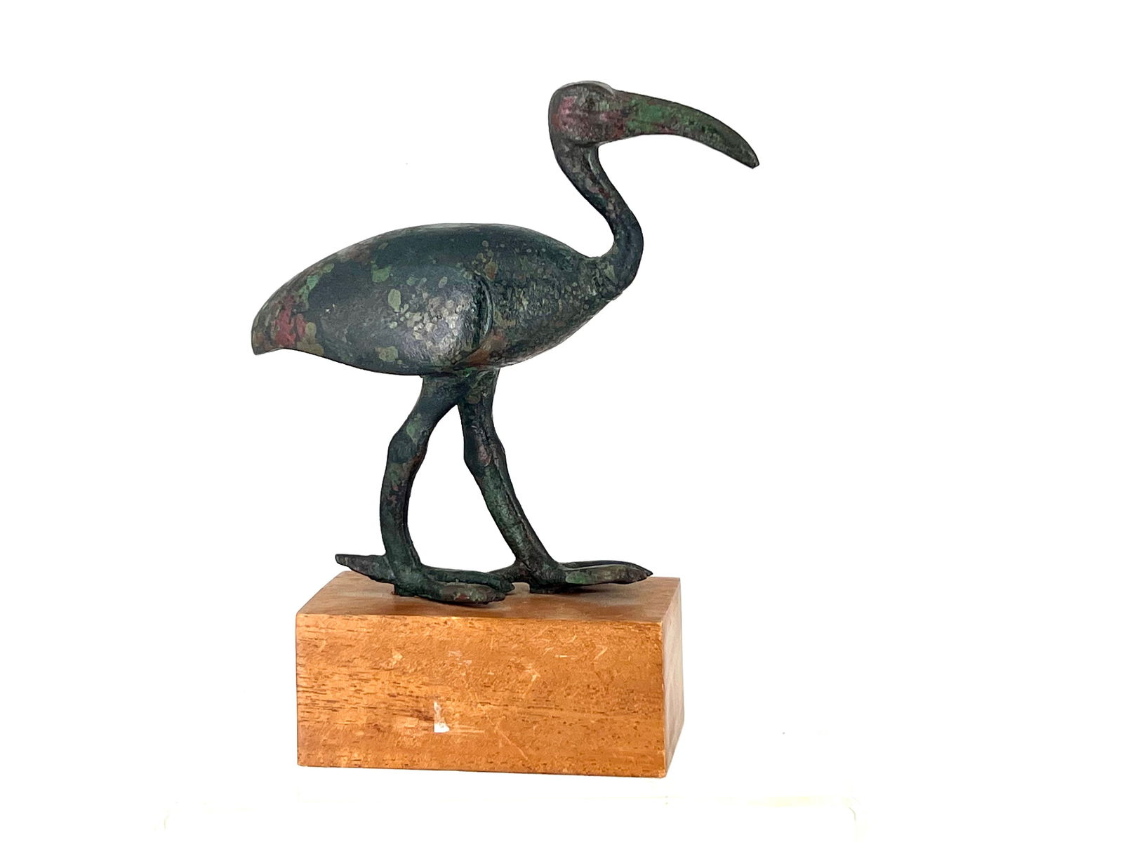 A beautiful Egyptian bronze ibis. 7in: Large Egyptian bronze figure of an Ibis, dating to the Late Period, circa 664-332 BC. Modelled with left leg forward, the creature's distinctive bald head raised, its curved beak pointing at the groun