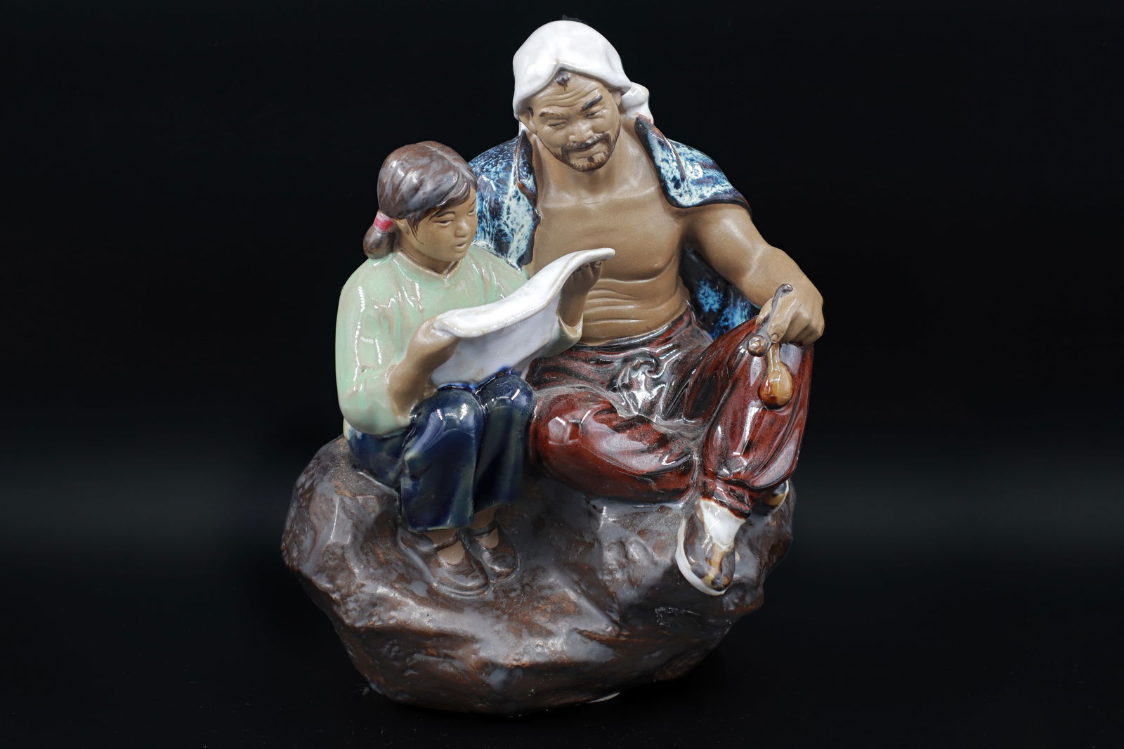 Chinese Shiwan Statuette Of Farmer With Daughter Reading Newspaper, Glazed Ceramic Figure, Oriental: Dimensions, Height 7.25 inches. All measurements are approximate. Surface wear and aging, A Corner of the newspaper was broken and glued back. Sold as is. Vintage 1980s Chinese Shiwan Statuette Of Far