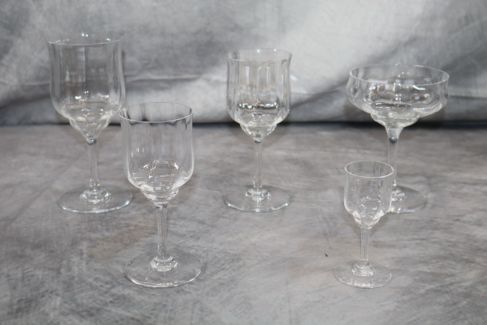 57pc Assorted Baccarat Crystal Glassware set: 57 pieces total, 12 large wine glasses, 12 wide cocktail glasses, 11 medium wine glasses, 11 small glasses, 11 after dinner cordial glasses.