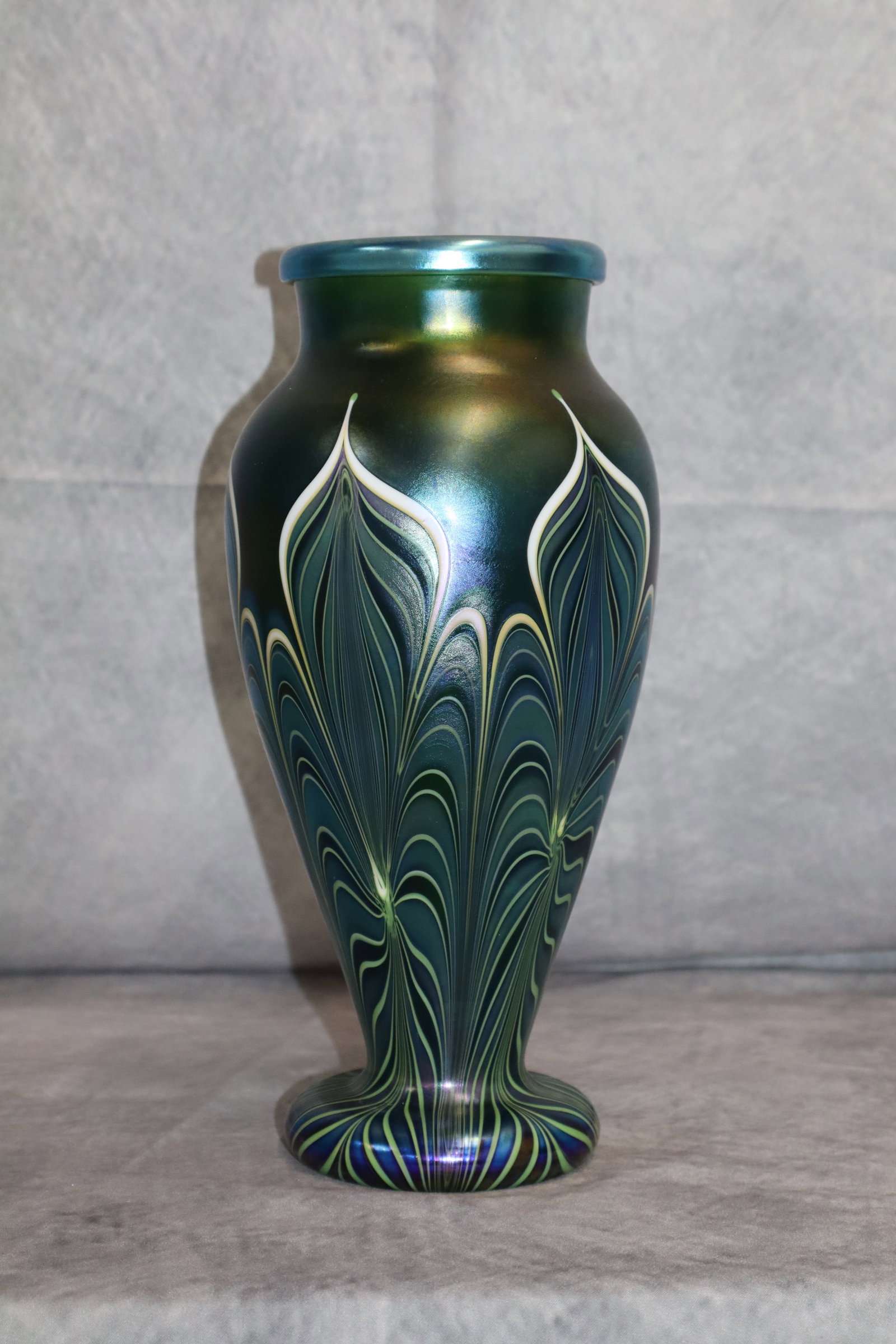 Orient and Flume art glass: Orient and flume iridescent art glass vase, stamped and signed on the bottom. Dimensions: H:10in D:4 1/2in