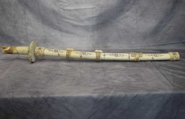 Oriental Bone Sword: Hand carved Oriental bone sword and sheath carving. In excellent condition. Dimensions: L:32in