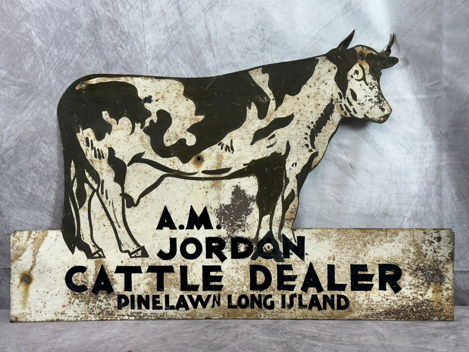 A.M. Jordan Cattle Dealer, Tin Sign: This is a vintage tin advertising sign for "A.M. Jordan Cattle Dealer," featuring a rustic and evocative depiction of a cow and calf. The sign showcases early 20th-century craftsmanship, with hand-pai