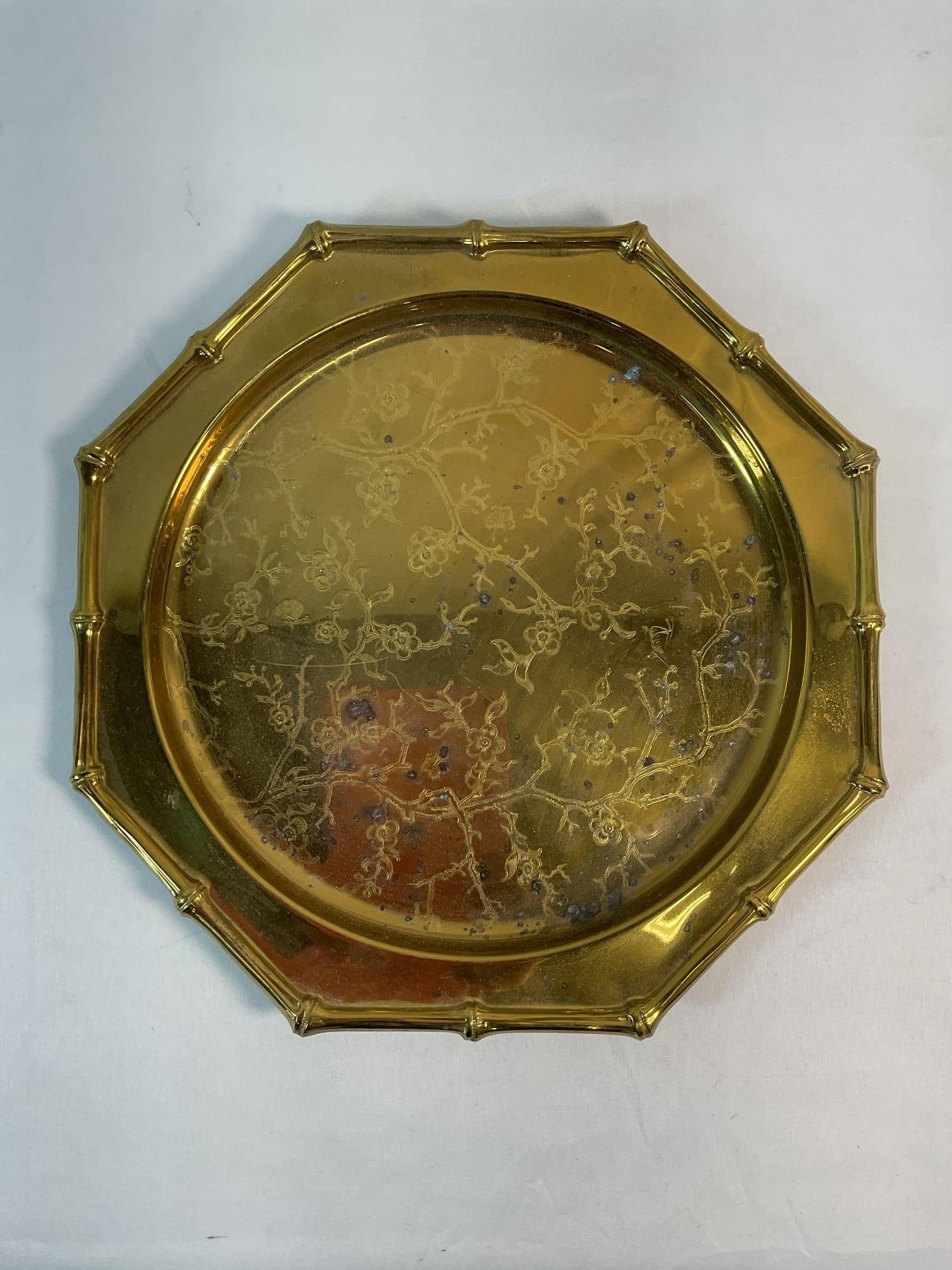 SEIDN Brass Tray / Plate: This is an ornately designed vintage brass tray or plate featuring an intricate embossed scene with figures and decorative elements. The tray has an octagonal shape, adding a unique and elegant touch