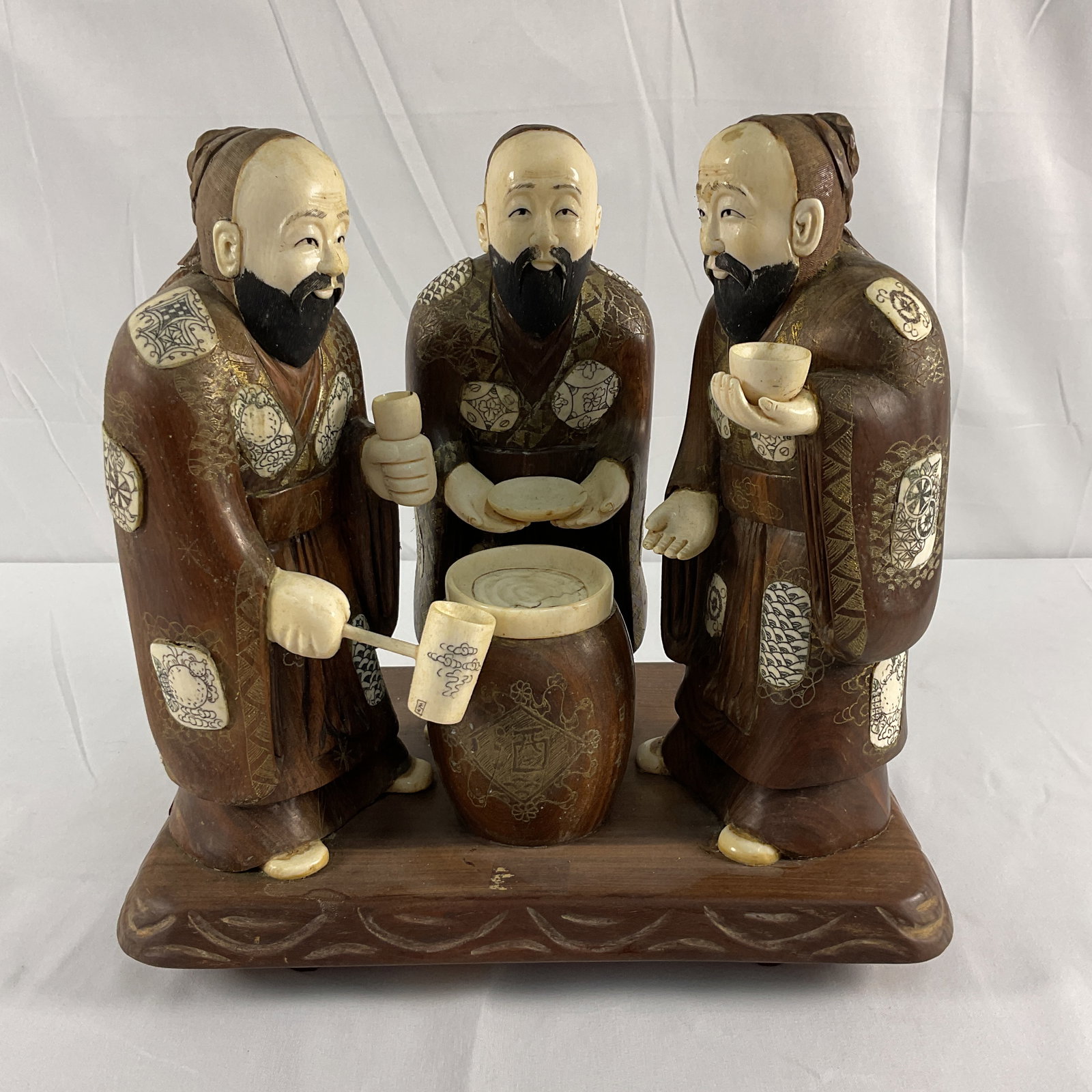 Chinese Bone Carving - 3 Bearded Men: Carved Bone Three figures with drum, on wooden base, H9in L10in W7in approx. This piece cannot be shipped out of state. Will be sold only to people with a valid Florida ID (Must be a Florida resident}